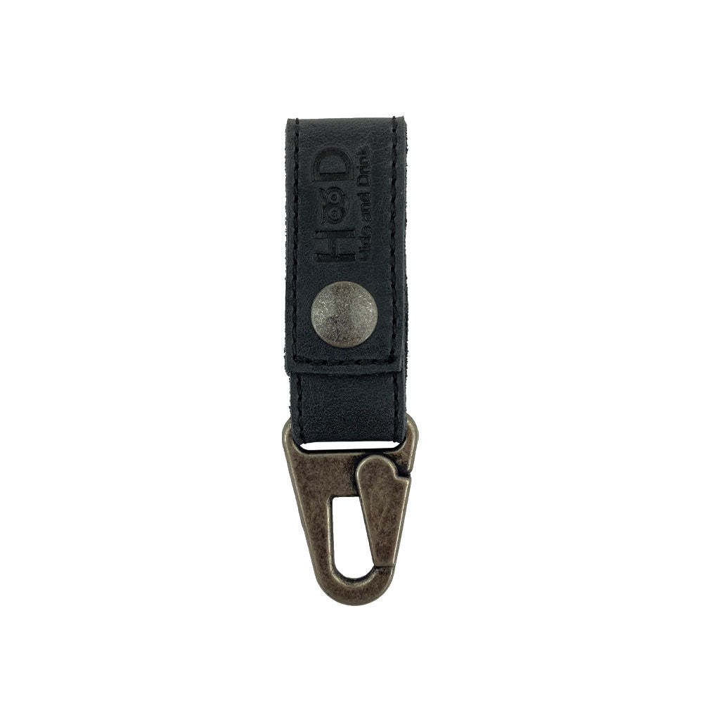 Front view of a black leather Key Ring Holder by Hide & Drink, crafted from Full Grain Leather. This artisan-made accessory boasts small batch production techniques, hand-cut and hand-sewn edges, and fire branding, all produced in La Antigua Guatemala & Oaxaca Mexico.