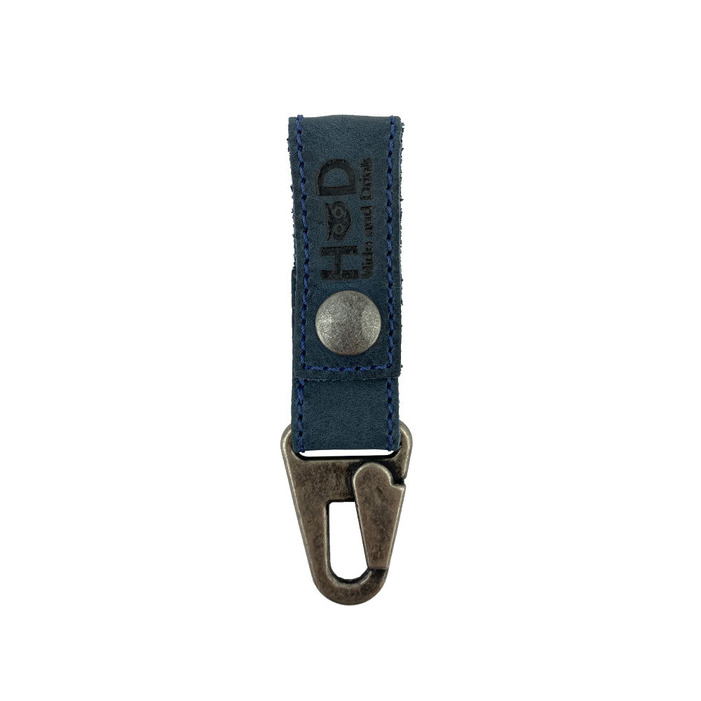 Key Ring Holder in blue leather by Hide & Drink, showcasing a rustic aesthetic. Made from Full Grain Leather, this holder is Hand Cut and Hand Sewn, representing Small Batch Production. Artisan crafted in La Antigua Guatemala & Oaxaca Mexico.