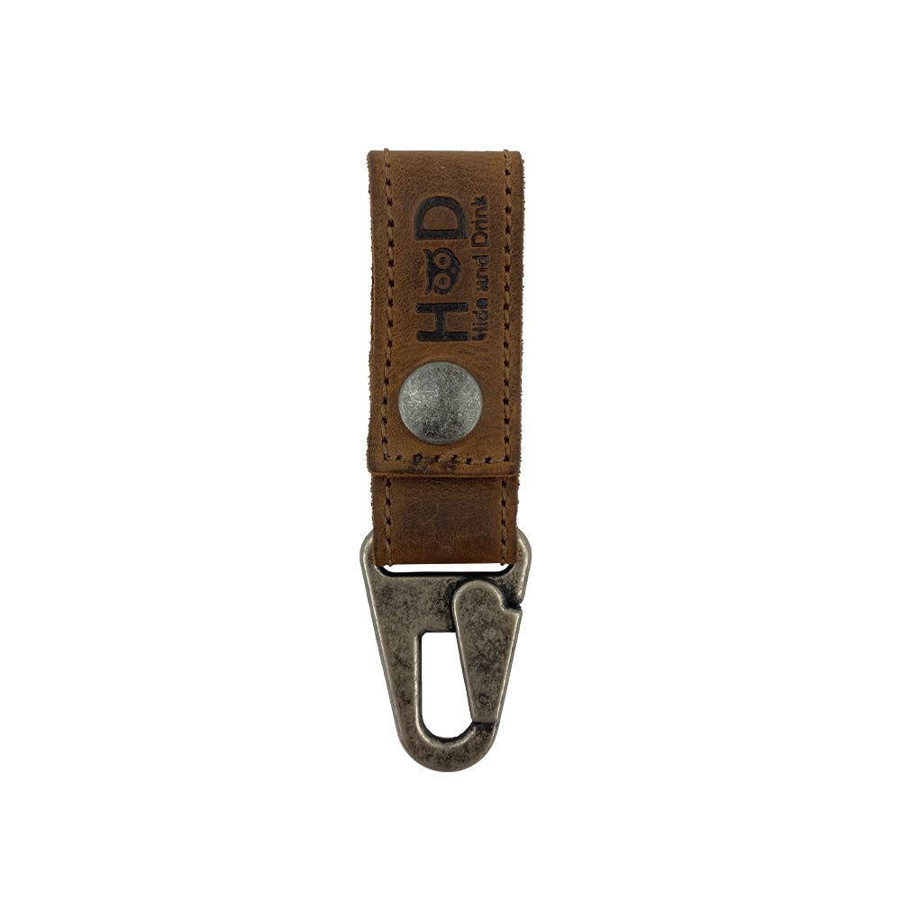 Key Ring Holder by Hide & Drink featuring a rustic Full Grain Leather design with metal snap. This artisan piece emphasizes small batch production, hand cut and hand sewn craftsmanship, and is fire branded, handmade in La Antigua Guatemala & Oaxaca Mexico.
