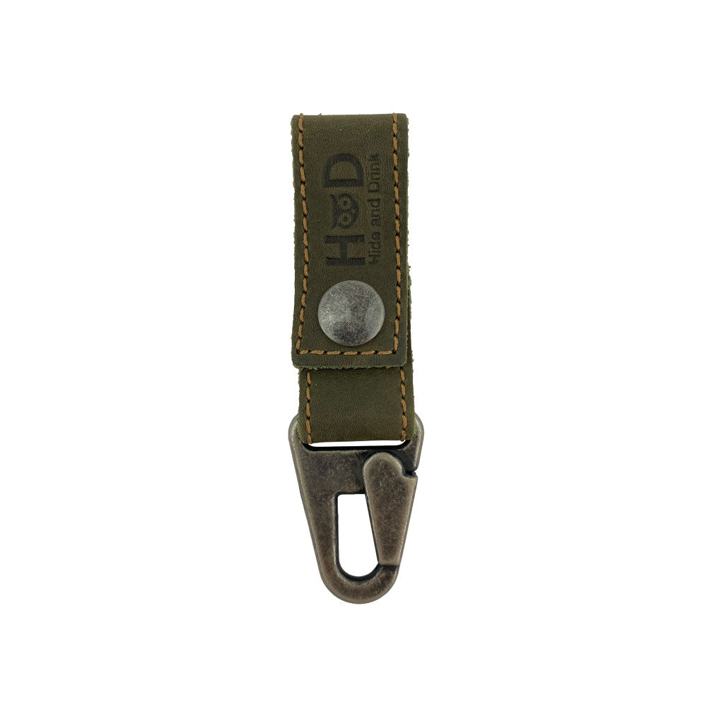 Hide & Drink Key Ring Holder in olive green leather, showcasing its distinctive design and high-quality Full Grain Leather. An artisan product, Hand Cut and Hand Sewn through Small Batch Production, perfect for stylish key organization.