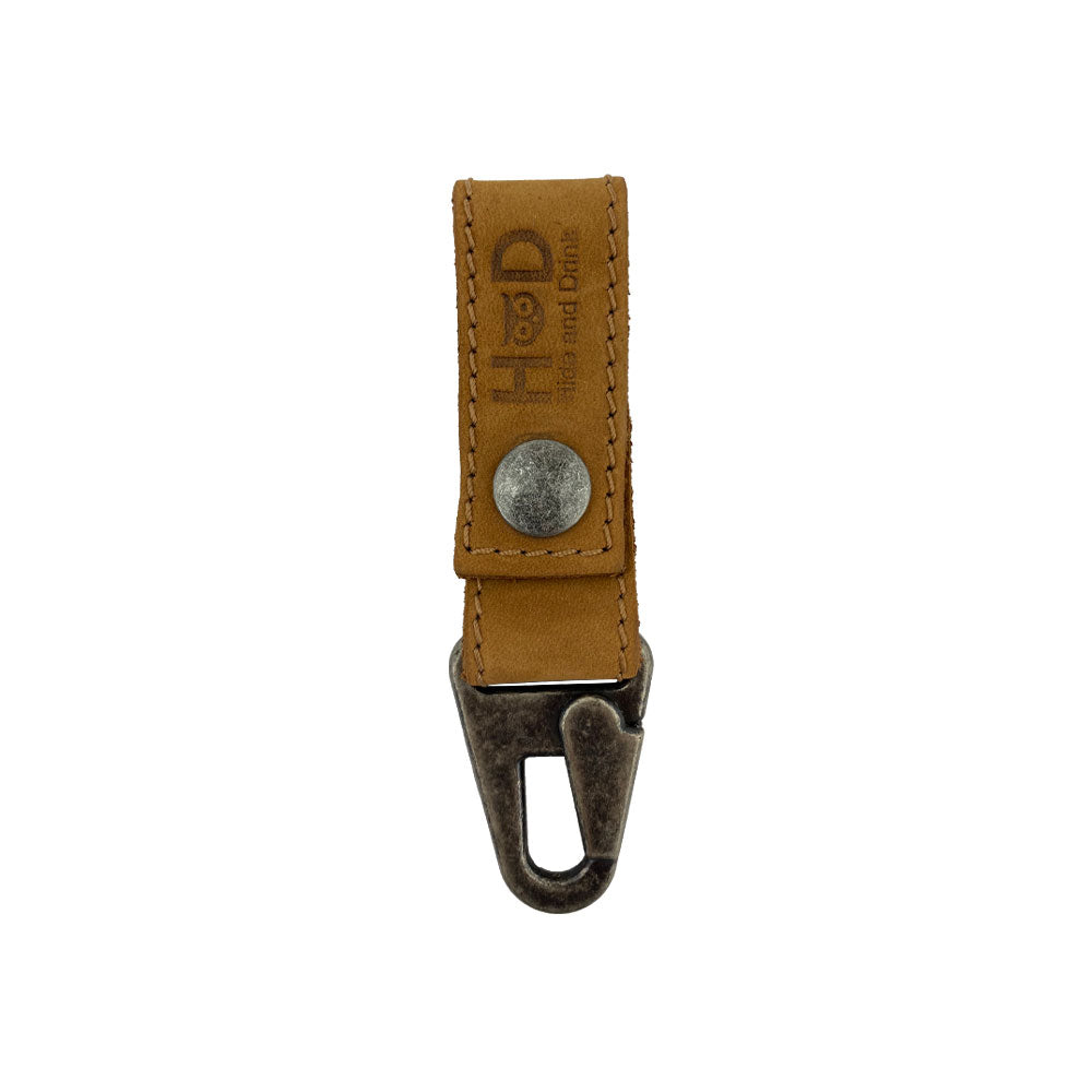 Leather Key Ring Holder by Hide & Drink in a warm color, emphasizing the Full Grain Leather used. This stylish holder is perfect for organizing keys, showcasing artisan craftsmanship, hand cut, hand sewn, and fire branded in La Antigua Guatemala & Oaxaca Mexico.