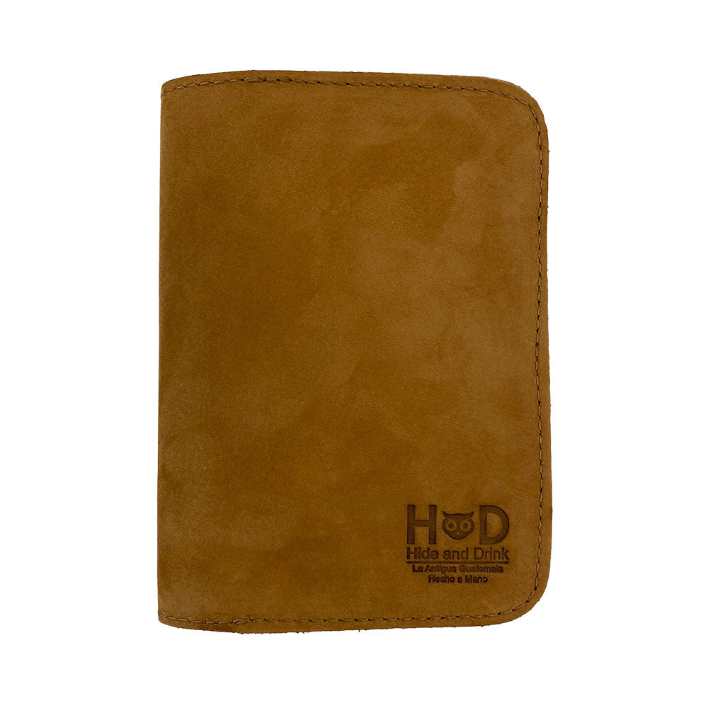 Exterior of the Hide & Drink Travel Wallet depicting its unique color. This travel wallet is an artisan-crafted bifold passport case detailed with high-quality leather in La Antigua Guatemala.