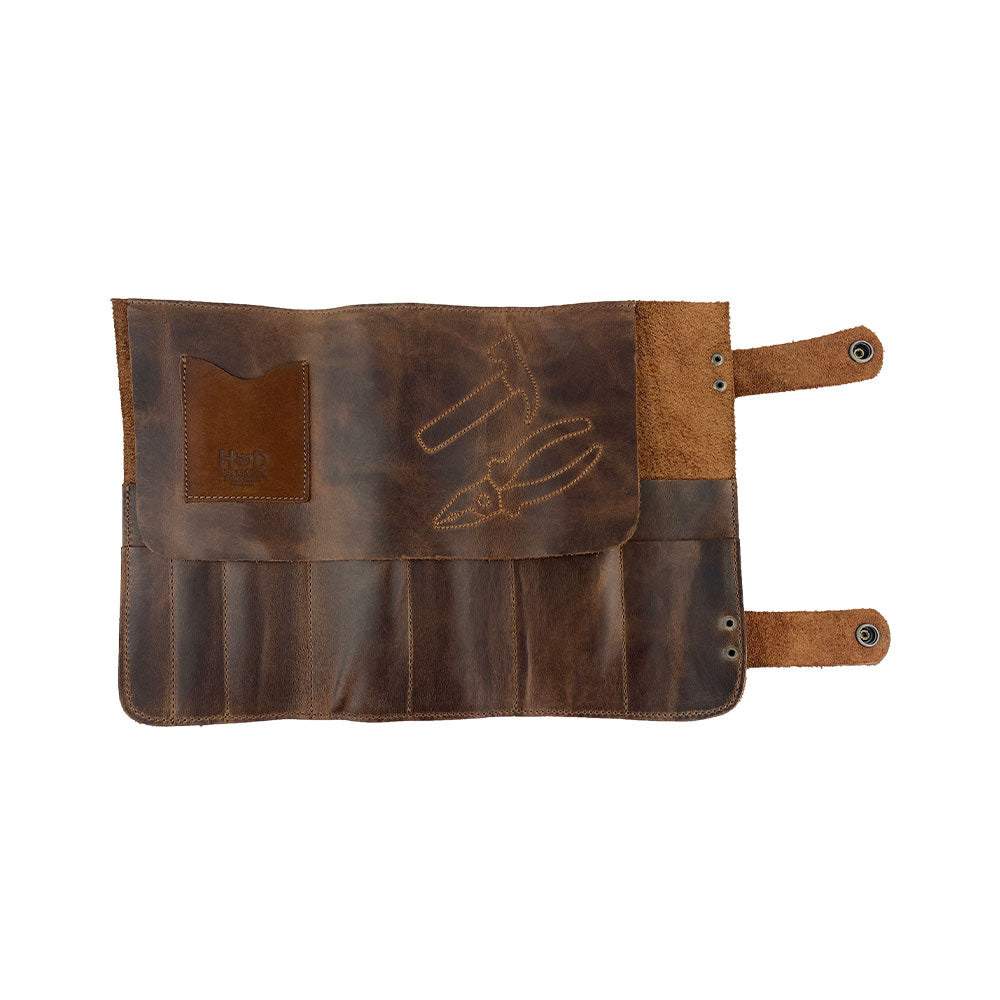 Hide & Drink's Barber Tool Roll features a Snap Tool Roll Up Bag with 14 Slots, perfect for organizing scissors & screwdrivers. This portable carry case is made from Full Grain Leather, highlighting StockyardX's commitment to artisan craftsmanship and small batch production, hand cut, hand sewn, and fire branded in La Antigua Guatemala & Oaxaca Mexico.