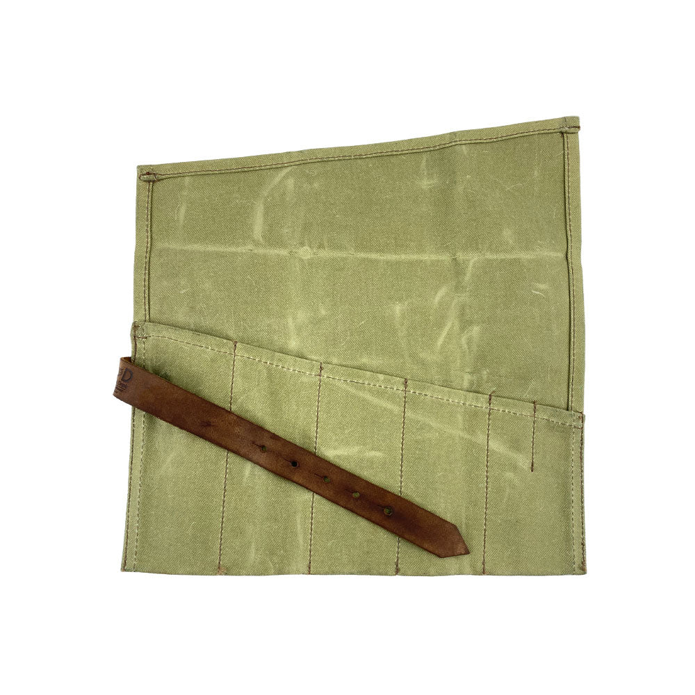A detailed Large Tool Roll from Hide & Drink, showcasing its functional design. This Portable Carry-On Pouch includes 6 slots for successful woodworking tools organization. Constructed with waxed canvas and full grain leather variations, this artisan item exemplifies commitment to hand-cut and hand-sewn quality, handmade in La Antigua Guatemala & Oaxaca Mexico.