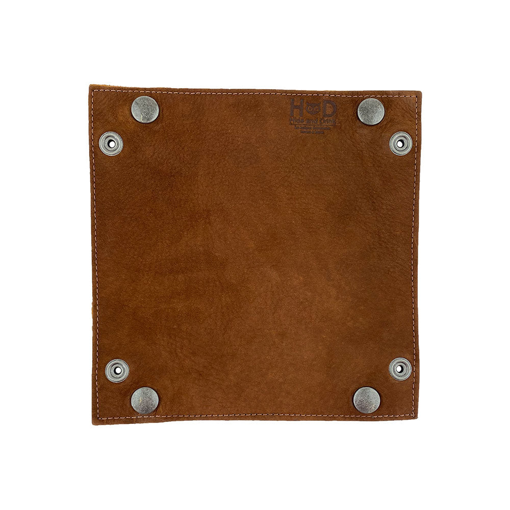 The underside of the Valet Tray with Sheep Skin by Hide & Drink featuring brass snaps and showing the high quality of the leather used. This handmade tray is ideal for organizing change and keys, and highlights the artisanal connection from La Antigua Guatemala & Oaxaca Mexico. Crafted with Full Grain Leather & Sheepskin, it's a must-have for anyone seeking a stylish storage valet.