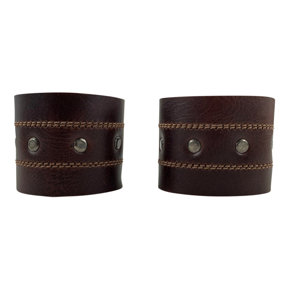 A stylish Men's Wristband by Hide & Drink, featuring a criss-cross design made from high-quality full grain leather. This handmade accessory showcases expert craftsmanship with fine stitching, making it a perfect fit for any outfit. Men's Wristband Handmade, Full Grain Leather, StockyardX, Small Batch Production, Hand Cut, Hand Sewn, Fire Branded, Artisan, Handmade in La Antigua Guatemala & Oaxaca Mexico.