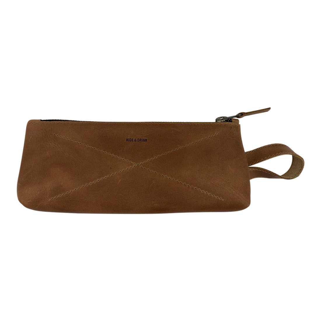 Hide & Drink's X Stitched Case, showcasing a warm brown finish, acts as a perfect organizer for pens and small cosmetics. An artisan handmade piece made from full grain leather in La Antigua Guatemala and Oaxaca, Mexico, this item reflects quality craftsmanship.