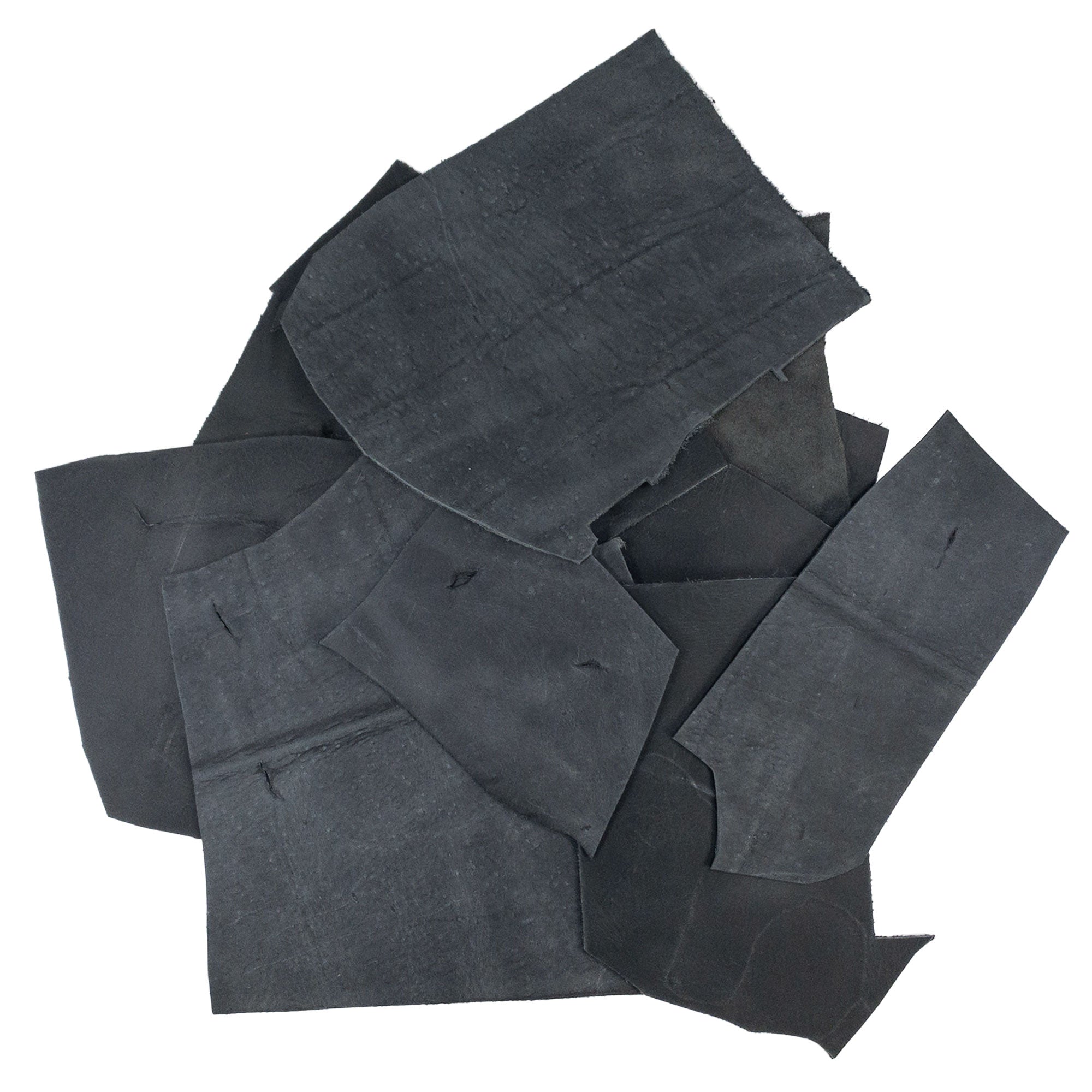 Hide & Drink Leather Scraps With Scars (12 oz pack) displaying a bundle of full grain leather scraps ideal for crafting. Each hand cut piece features distinctive scars, enhancing the character of your project. Measuring approximately 8 inches in length, these varying widths offer versatility and are crafted in La Antigua Guatemala.