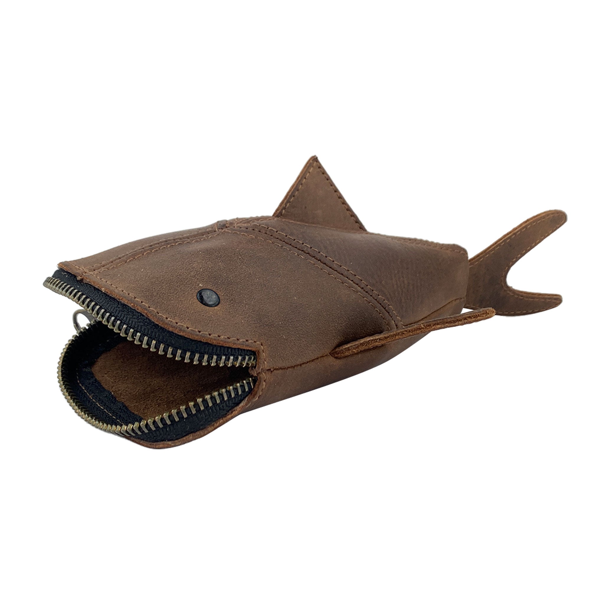Viewing the brown Leather Shark Pouch from Hide & Drink, this zippered pouch highlights its shark shaped design. Ideal as a change bag or pencil purse, it is made from full grain leather, showcasing artisan craftsmanship from La Antigua Guatemala & Oaxaca Mexico with high standards of small batch production.