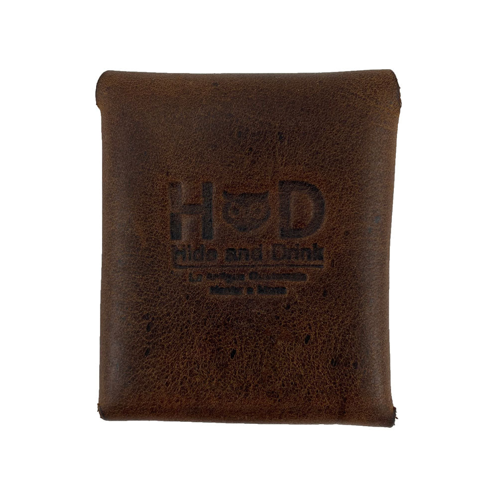 Back view of the Minimalist Square Coin Pouch by Hide & Drink, highlighting the embossed logo. Crafted from durable full grain leather in a chic, minimalist style, it’s the ideal accessory for organizing small items. Minimalist Coin Pouch, SD Card Holder, Wallet and Cash Organizer, Full Grain Leather, StockyardX, Small Batch Production, Hand Cut, Hand Sewn, Fire Branded, Artisan, Handmade in La Antigua Guatemala & Oaxaca Mexico.