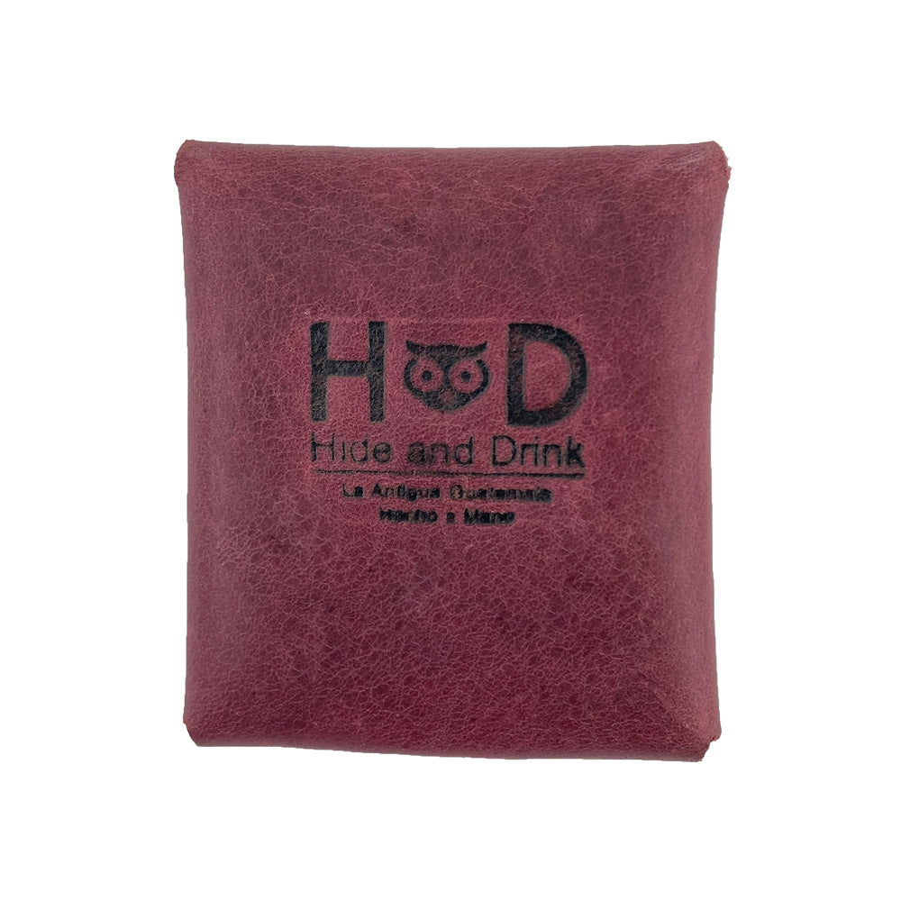 Back view of a burgundy Minimalist Square Coin Pouch by Hide & Drink, featuring the embossed brand logo. This artisan-crafted leather pouch combines functionality with design, perfect for those who appreciate minimalist elegance. Minimalist Coin Pouch, SD Card Holder, Wallet and Cash Organizer, Full Grain Leather, StockyardX, Small Batch Production, Hand Cut, Hand Sewn, Fire Branded, Artisan, Handmade in La Antigua Guatemala & Oaxaca Mexico.