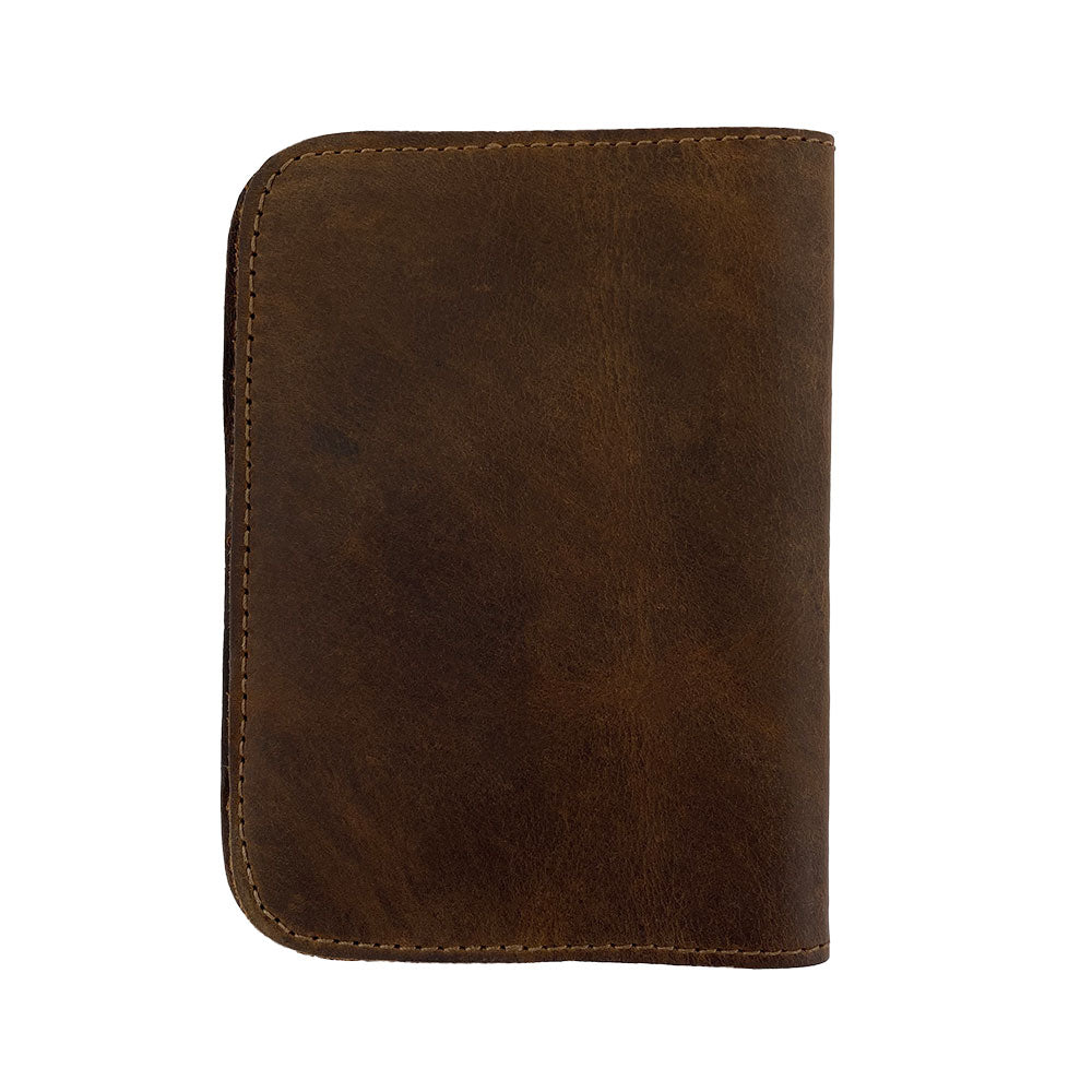 Detailed look at the inside of the Hide & Drink Travel Wallet, displaying card slots and cash pockets. This handmade travel wallet is a stylish bifold passport case, crafted from full grain leather in La Antigua Guatemala.