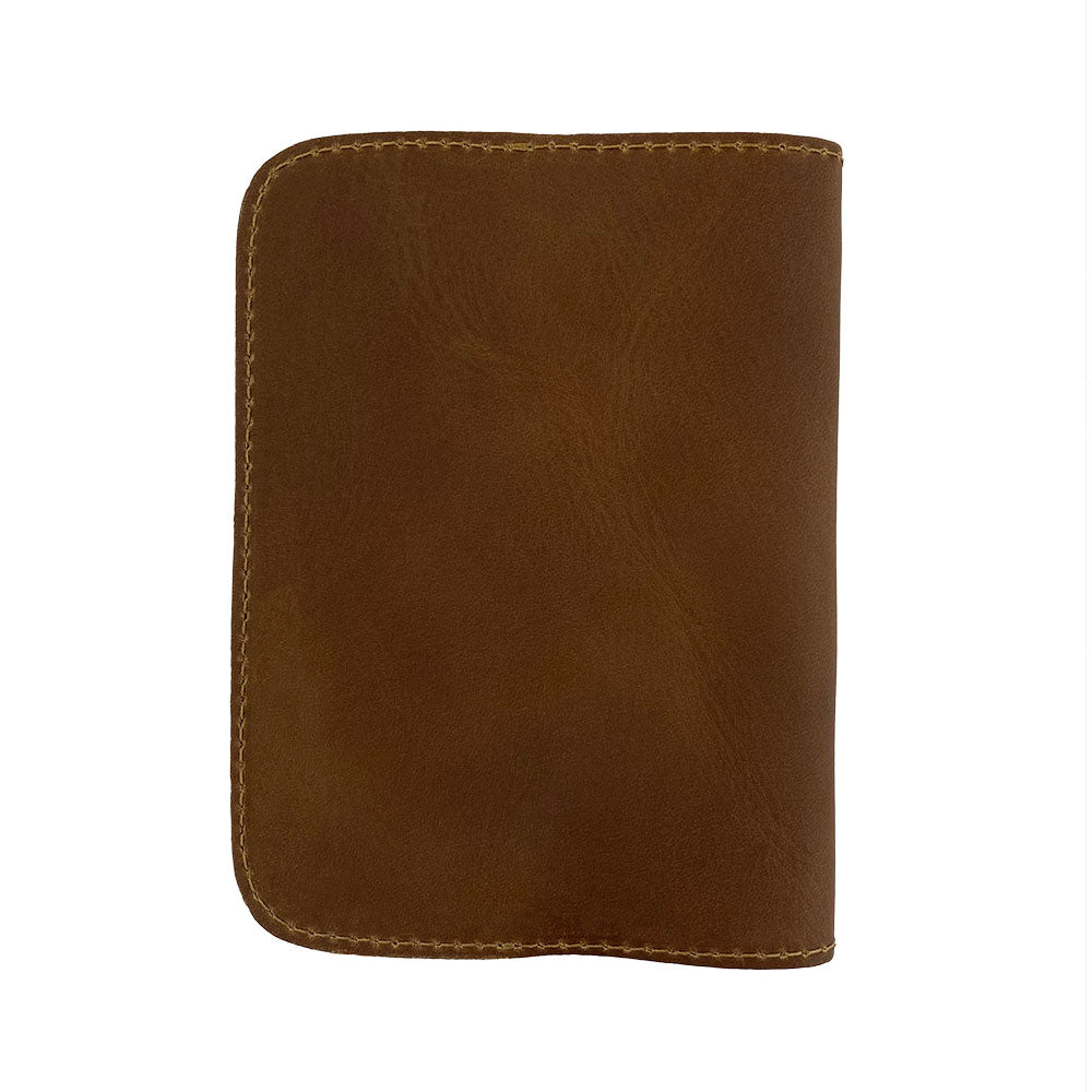 Side view of the Hide & Drink Travel Wallet showcasing the sleek design. As a bifold passport case and money holder, this travel wallet is artisan-crafted from premium leather in La Antigua Guatemala.