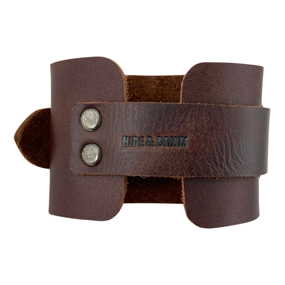 Close-up of the Hide & Drink Wristband, emphasizing the sleek design and comfortable fit. This wrist accessory merges style and durability, characterized as Wristband with Ring Decoration Full Grain Leather. Crafted by StockyardX through small batch production methods, the piece is hand cut, hand sewn, and fire branded by skilled artisans in La Antigua Guatemala & Oaxaca Mexico.