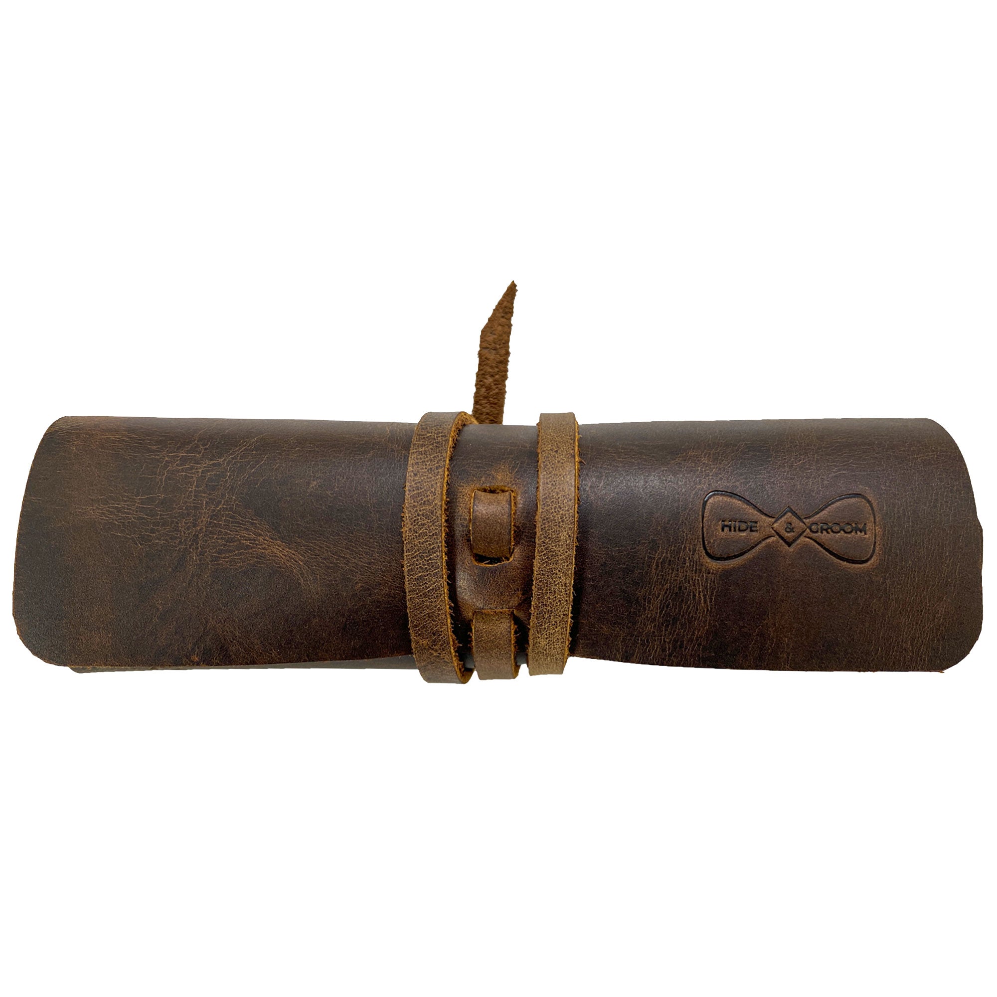 Hide & Groom Shaving Brush Roll made of full grain leather, perfect for travel and grooming essentials, featuring minimalist style and handmade in La Antigua Guatemala. This shaving brush roll is designed for personal care as a toiletry organizer. StockyardX collaborates on this small batch production with artisan craftsmanship, showcasing hand cut and hand sewn details, finished with fire branding.