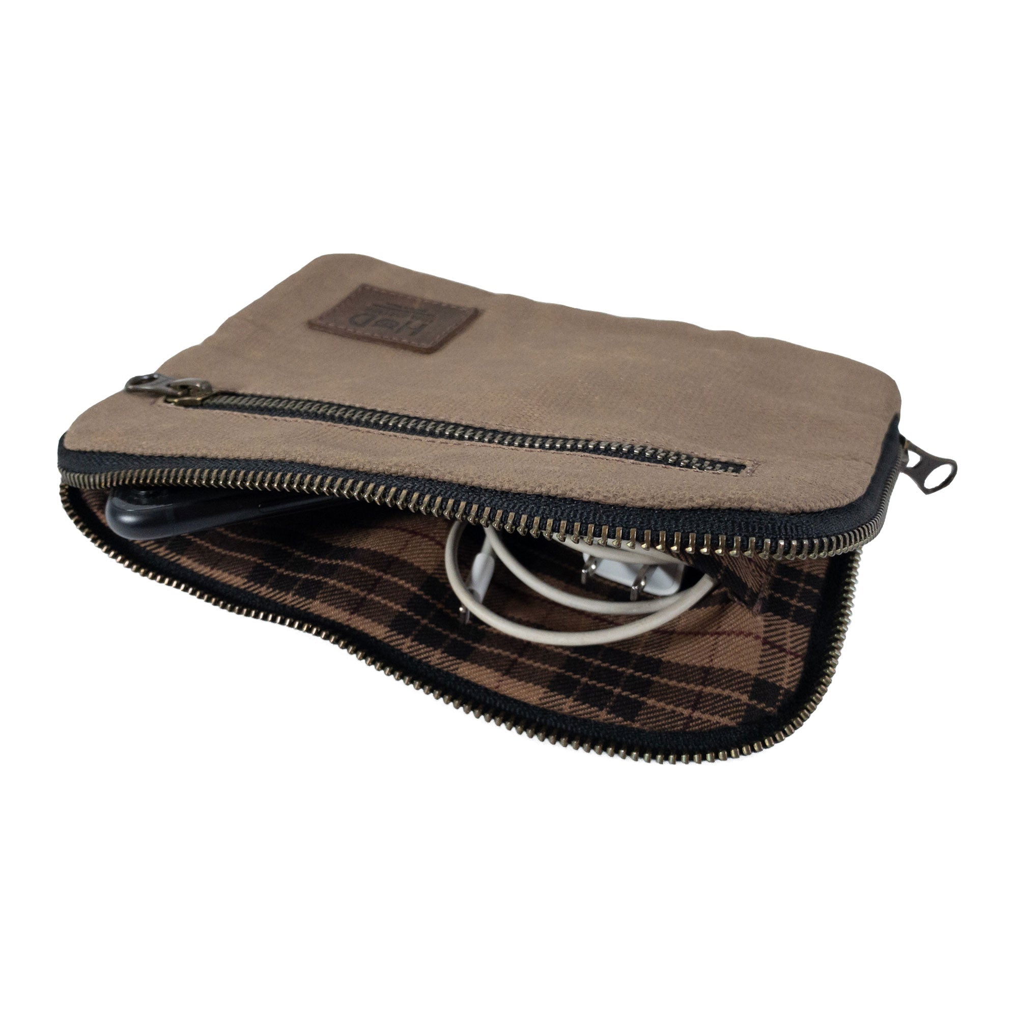 Interior view of Hide & Drink's brown Zipper Gear Pouch with organized electronics, illustrating its multi-purpose functionality and hand-sewn quality, crafted from water resistant waxed canvas.
