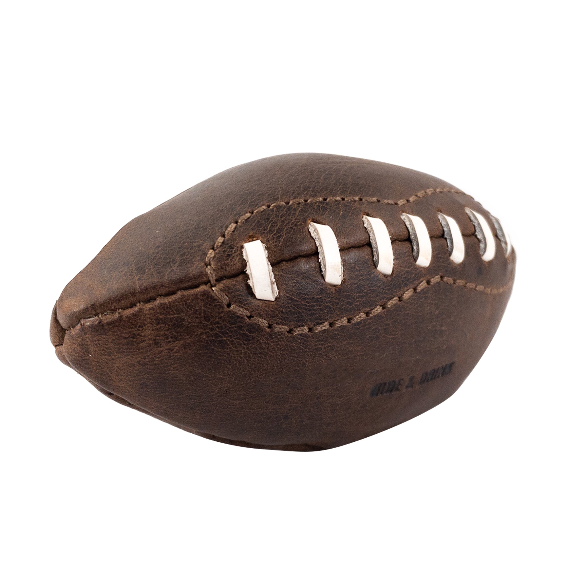 Side view of a Mini American Football by Hide & Drink, featuring authentic white laces and unique leather texture. Perfect as memorabilia or a decorative piece, this hand sewn ball is handmade in La Antigua Guatemala & Oaxaca Mexico, representing quality craftsmanship and artisan skills.