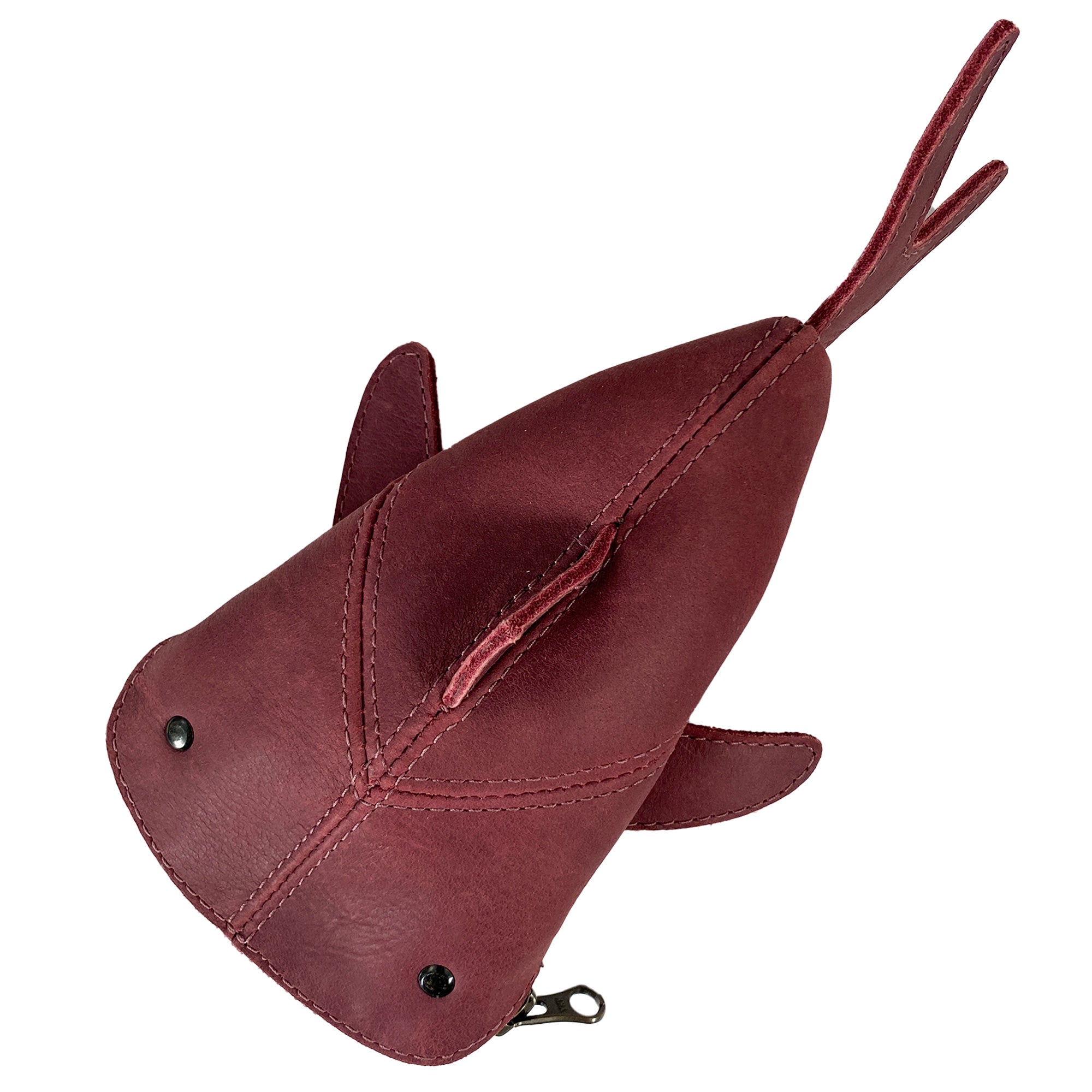 Top view of the red Leather Shark Pouch from Hide & Drink highlighting its distinctive shark shape. This zippered pouch is perfect for organizing smaller items and can function as a pencil purse or change bag. Each pouch is artisan-made from full grain leather in La Antigua Guatemala & Oaxaca Mexico, ensuring small batch quality.