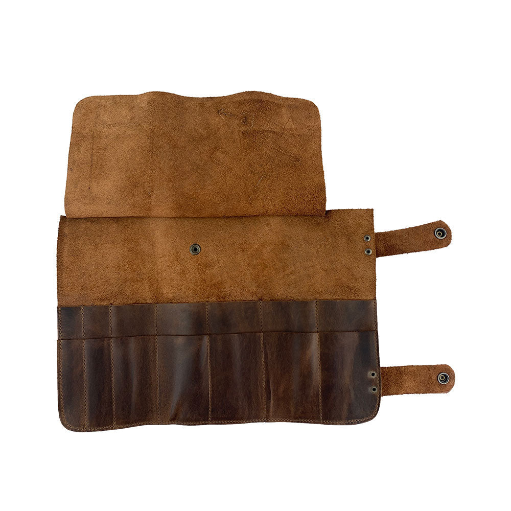 Hide & Drink's Barber Tool Roll showcases a Snap Tool Roll Up Bag with 14 Slots, ideal for efficient storage of scissors & screwdrivers. Made from Full Grain Leather, this portable carry case represents StockyardX's dedication to small batch production and artisan craftsmanship, hand cut, hand sewn, and fire branded in La Antigua Guatemala & Oaxaca Mexico.