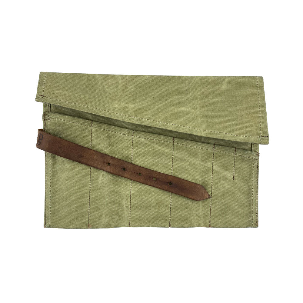 A stylish Large Tool Roll by Hide & Drink presented for display. This Portable Carry-On Pouch includes 6 slots for effective woodworking tools organization. Made from durable waxed canvas and full grain leather variations, this artisan piece showcases exceptional craftsmanship, hand cut and hand sewn in La Antigua Guatemala & Oaxaca Mexico.