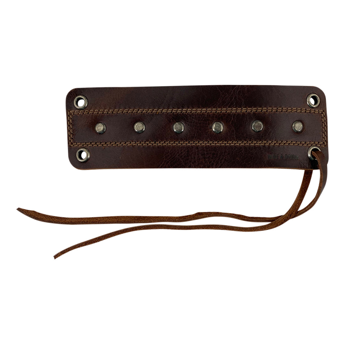 Close-up view of the Men's Wristband by Hide & Drink, highlighting the intricate details and metal accents in its sturdy full grain leather design. This wristband combines durability and style, perfect for fashion-forward individuals. Men's Wristband Handmade, Full Grain Leather, StockyardX, Small Batch Production, Hand Cut, Hand Sewn, Fire Branded, Artisan, Handmade in La Antigua Guatemala & Oaxaca Mexico.