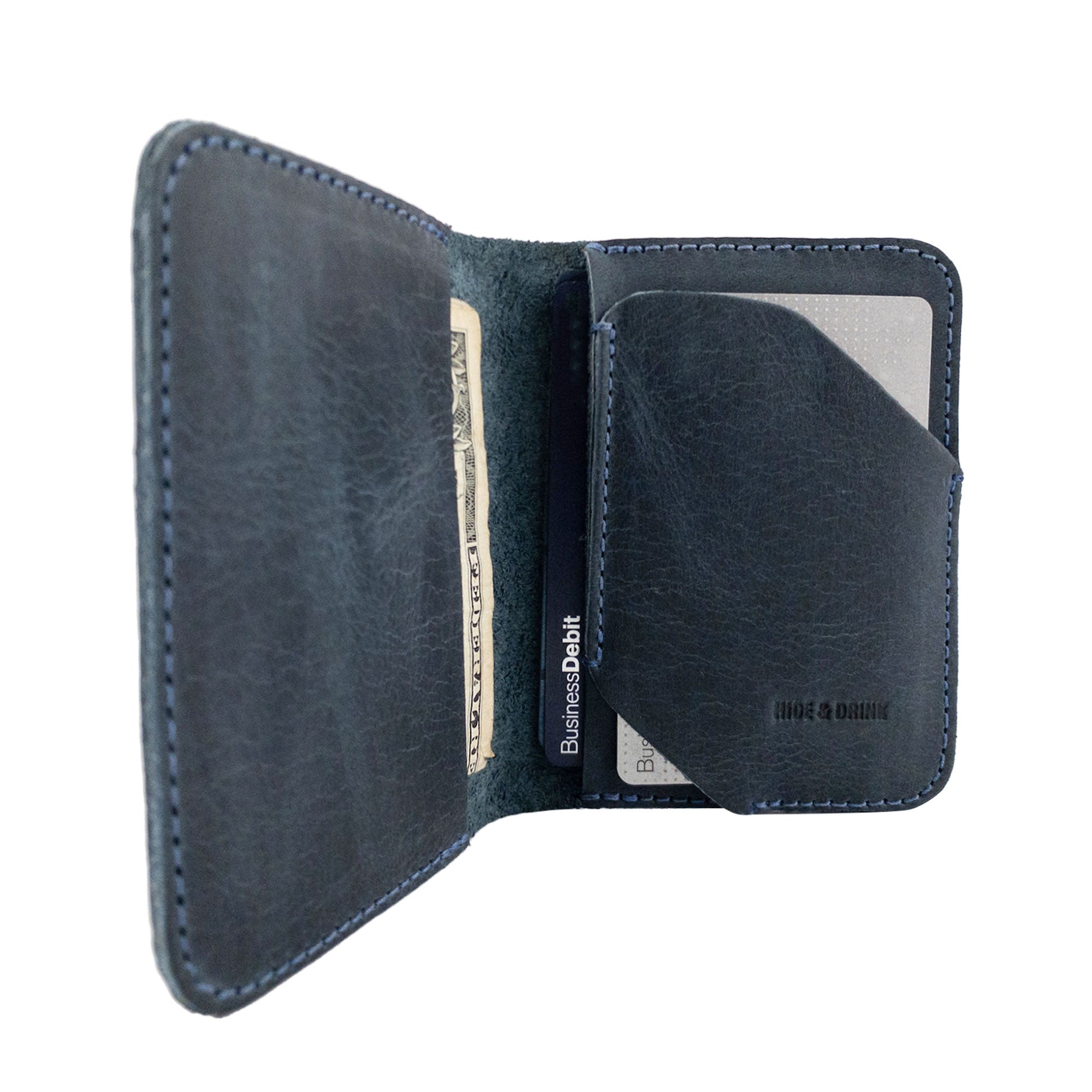 Open view of the Bi-Fold Card Wallet Diagonal by Hide & Drink in brown, illustrating its functionality as a stylish cash and card organizer made from durable leather.