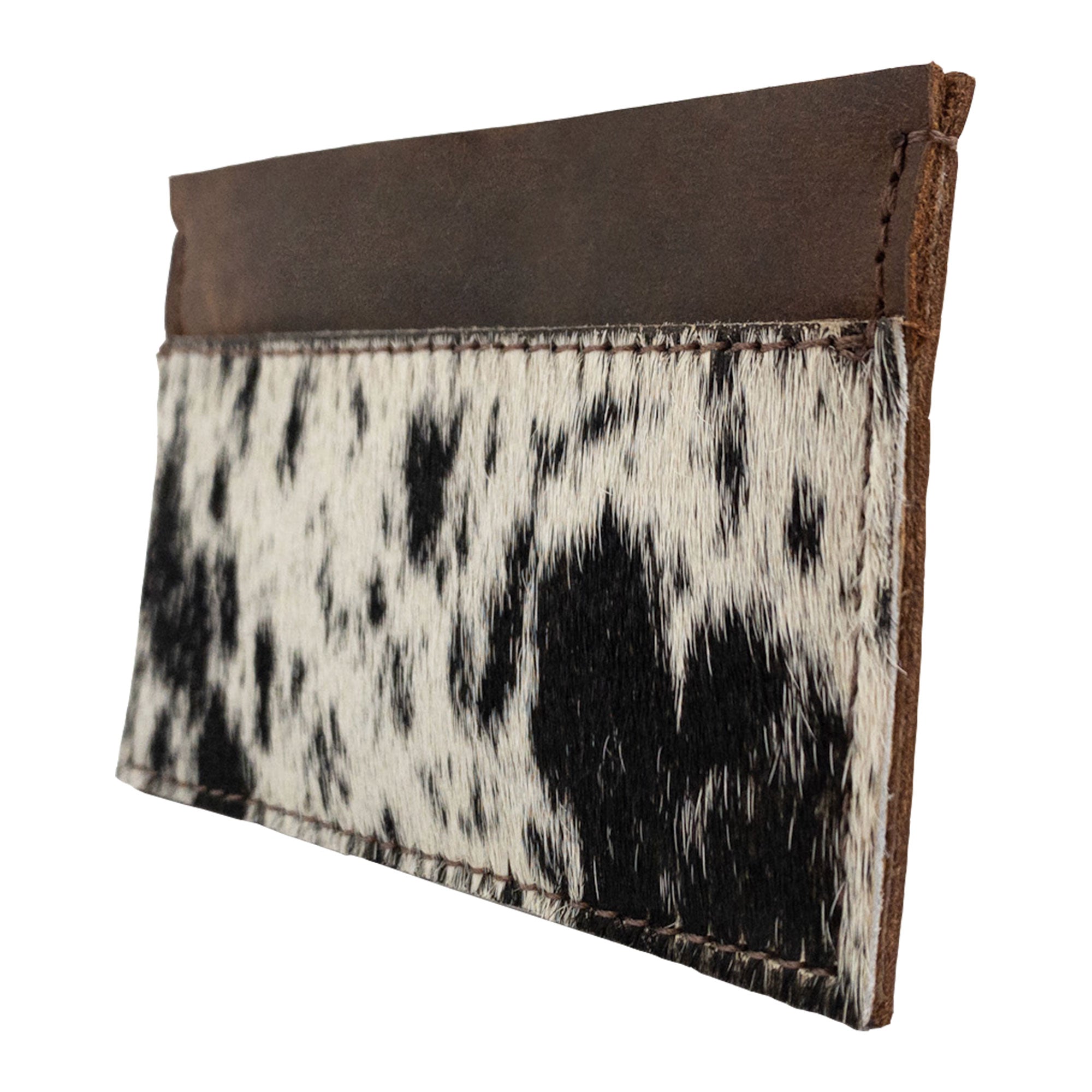 Side view of the Western Leather Works Double Card Wallet crafted from hair-on-hide full grain leather. This Minimalist Rodeo Wallet is perfect for compact storage needs, functioning well as an ID holder or travel accessory. Handmade by artisans in La Antigua Guatemala, emphasizing small batch production and meticulous hand stitching.