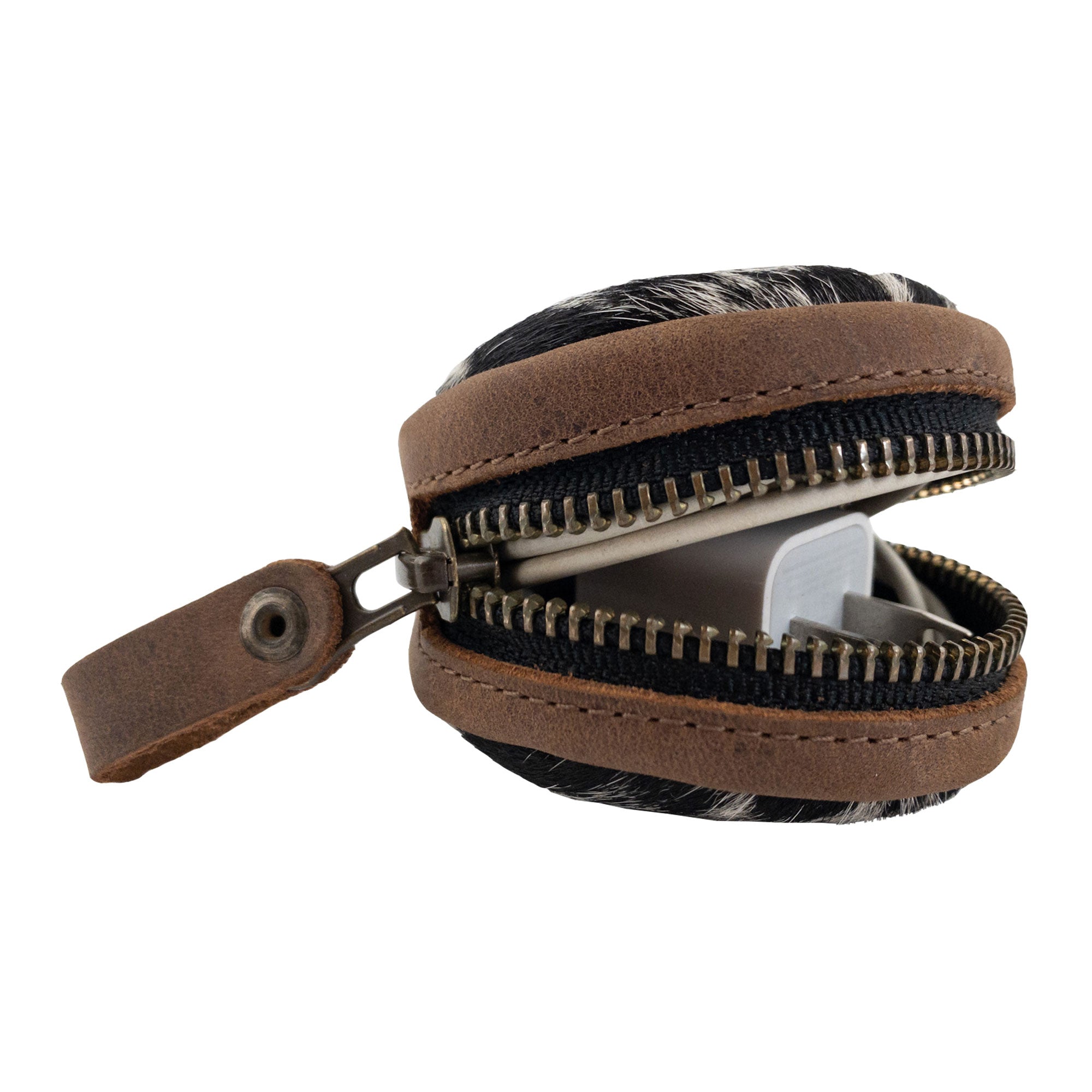 An angled view of the Rounded Coin Case by Western Leather Works, opened slightly to reveal its spacious interior. This handy pouch, made from high-quality hair-on-hide leather, is a versatile organizer for coins and small essentials, making it an excellent travel accessory. Handmade in La Antigua Guatemala, it reflects true artisan craftsmanship through its details.