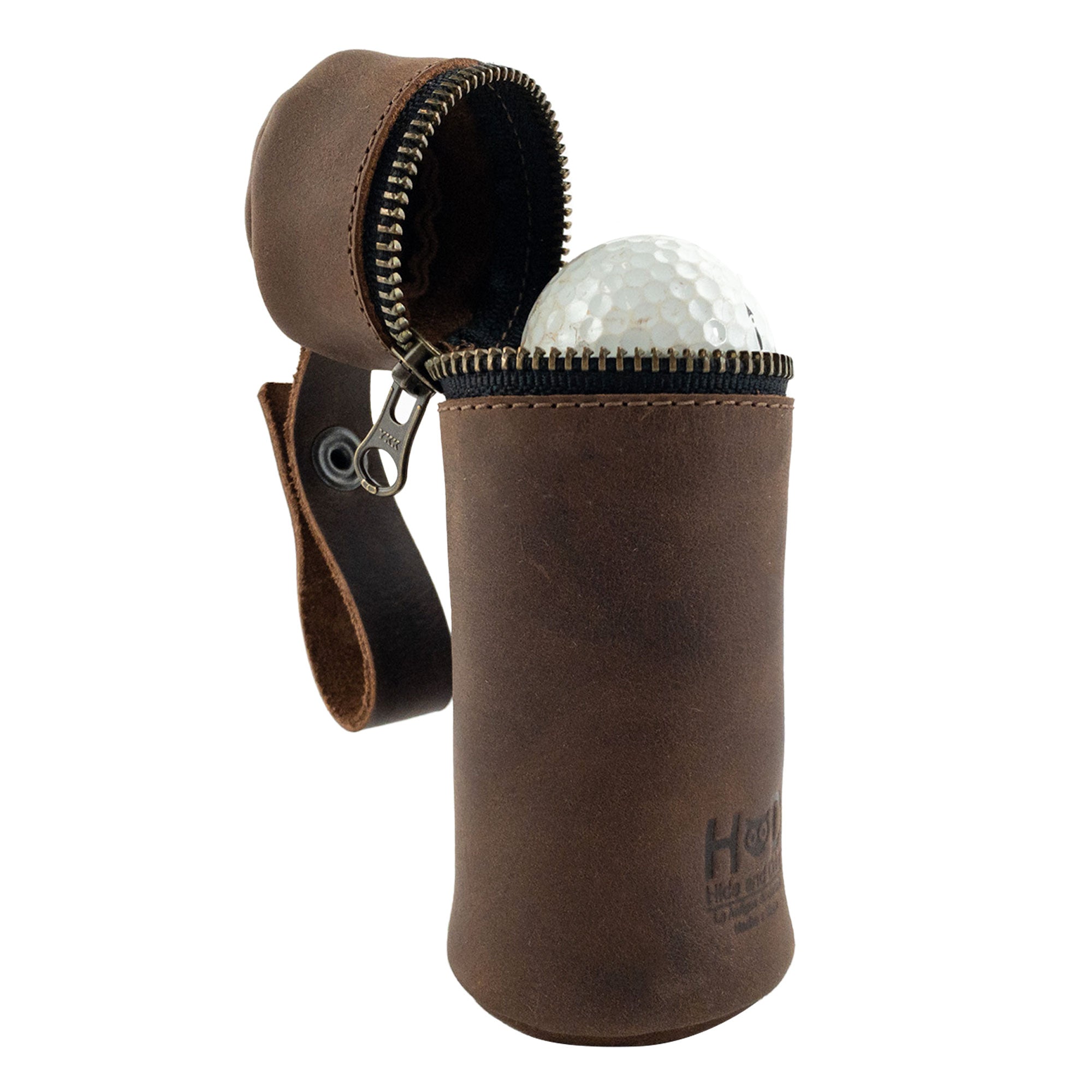 Open view of Hide & Drink's Cylinder Case for Golf Balls, displaying a golf ball inside. This artisan-crafted portable case is made of full grain leather, making it a must-have sports accessory. The convenient hanger makes it easy to carry, showcasing the dedication to small batch production in La Antigua Guatemala & Oaxaca Mexico.