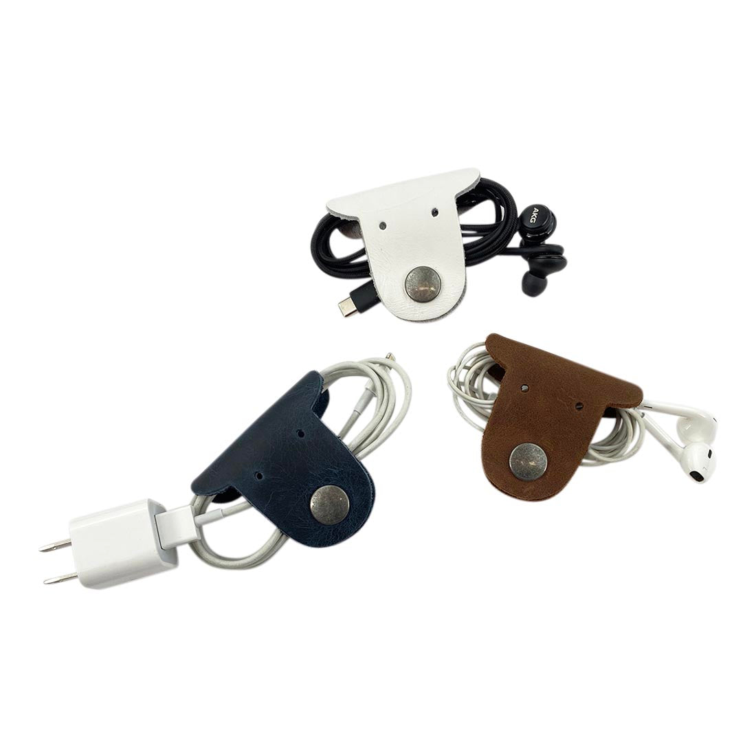 Multicolor Dog Cord Keeper (3 Pack) by Taco Dog featuring neatly wrapped cords secured with dog-shaped leather clips, showing the versatility of the organizers for different accessories. Dog Cord Keeper - Wrap Up Your Cables, Earbuds, Headphones, Chargers - Clip The Straps Together for Easy Management and Travel - 3-Pack, Full Grain Leather, StockyardX, Small Batch Production, Hand Cut, Hand Sewn, Fire Branded, Artisan, Handmade in La Antigua Guatemala & Oaxaca Mexico.
