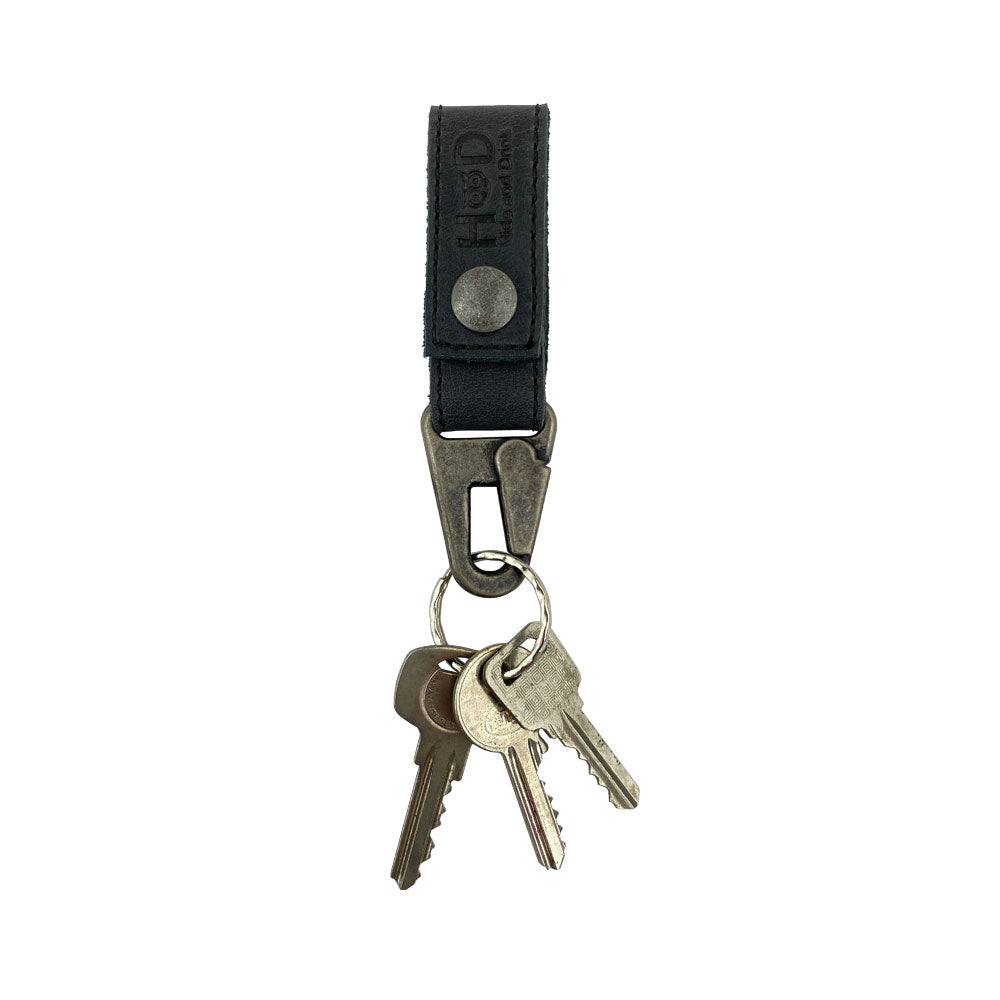 Stylish Key Ring Holder by Hide & Drink with keys attached, highlighting its Full Grain Leather construction. A great accessory for organization, featuring small batch production, hand cut, hand sewn, and fire branded detailing.