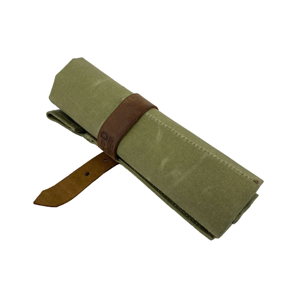 The Large Tool Roll by Hide & Drink featuring an elegant design. This Portable Carry-On Pouch has 6 slots, perfect for efficient woodworking tools storage. Crafted from waxed canvas and full grain leather variations, this artisan product highlights quality hand-cut and hand-sewn craftsmanship, proudly made in La Antigua Guatemala & Oaxaca Mexico.