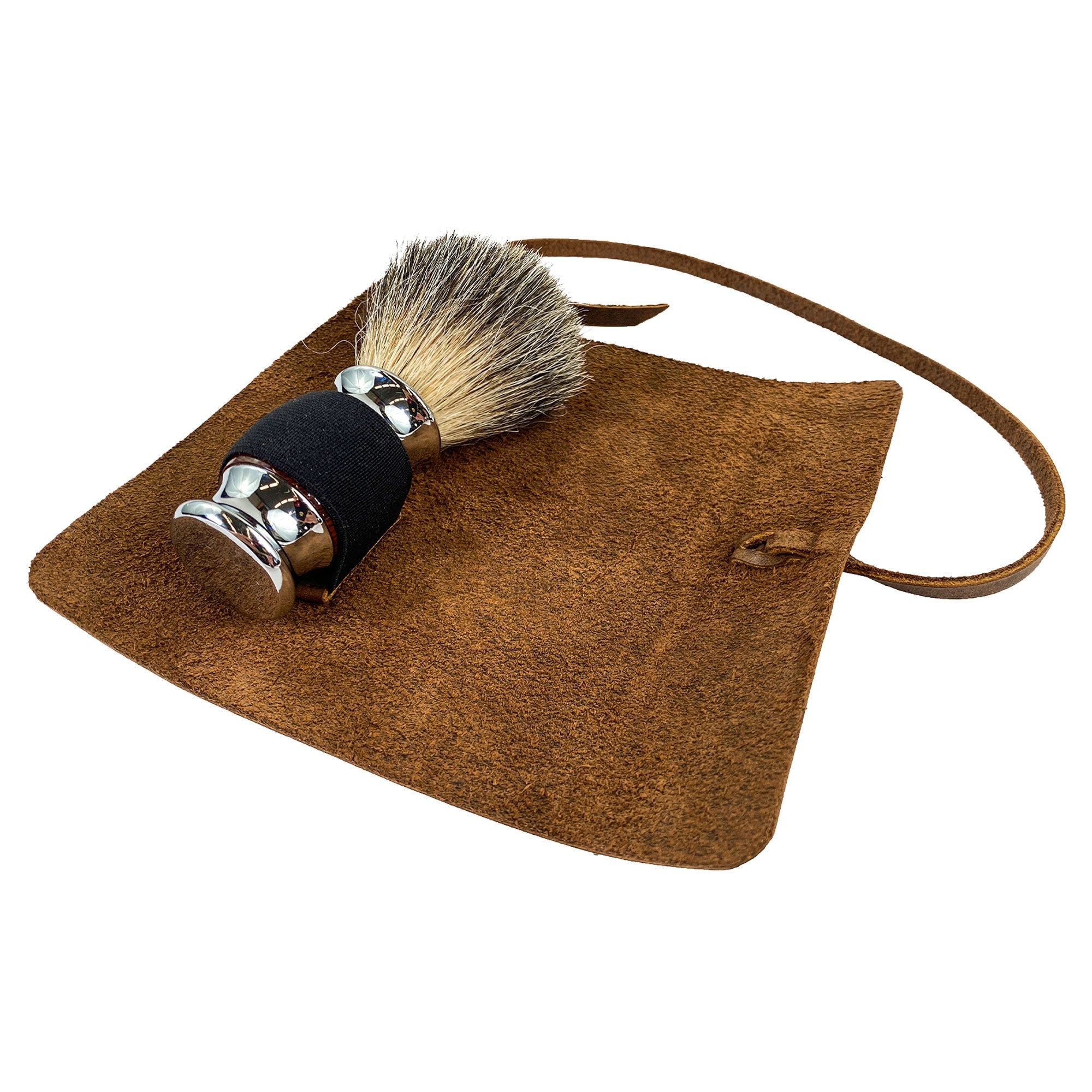 Hide & Groom Shaving Brush Roll in full grain leather, an essential toiletry organizer for grooming and travel needs. This handmade roll features a minimalist style, crafted in La Antigua Guatemala by skilled artisans. The piece emphasizes small batch production, with hand cut and hand sewn details, and fire branding for authenticity.