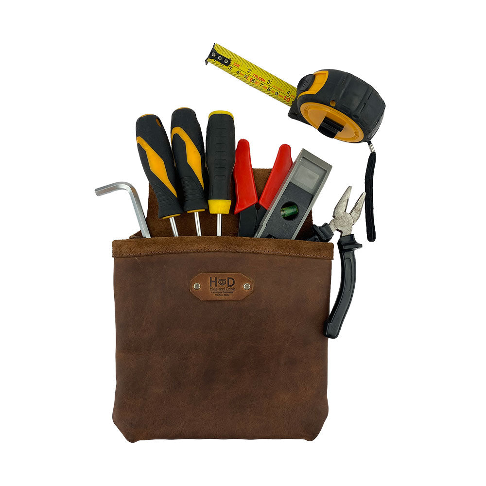 Constructor Belt Bag by Hide & Drink filled with tools, ideal for constructors. This durable tool bag features a single big pocket accessed easily while working. Made from full grain leather, it showcases fine craftsmanship in La Antigua Guatemala & Oaxaca Mexico.