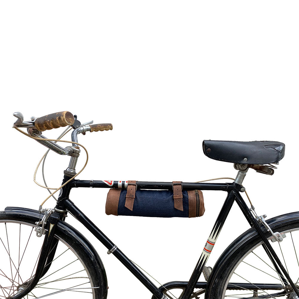 Bicycle showcasing the Navy Blue Bicycle Tube from Hide & Drink, perfect for securing drinks while biking. This Bike Pack Tube highlights the combination of functionality and stylish design, crafted from full grain leather and handcrafted in La Antigua Guatemala and Oaxaca Mexico.