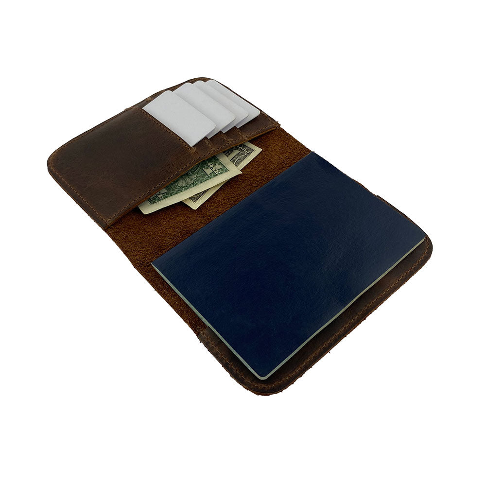 An open hide and drink Travel Wallet displaying the interior card slots and space for currency. This handmade classic wallet serves as a bifold passport case, crafted from full grain leather, perfect for travel accessories.