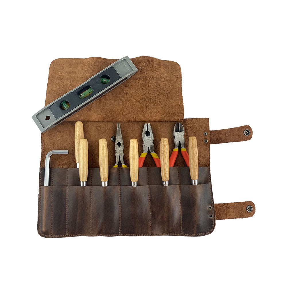 Hide & Drink's Barber Tool Roll displays a Snap Tool Roll Up Bag with 14 Slots for organizing scissors & screwdrivers. This portable carry case, made from durable Full Grain Leather, highlights StockyardX's artisan craftsmanship and dedication to small batch production, hand cut, hand sewn, and fire branded in La Antigua Guatemala & Oaxaca Mexico.