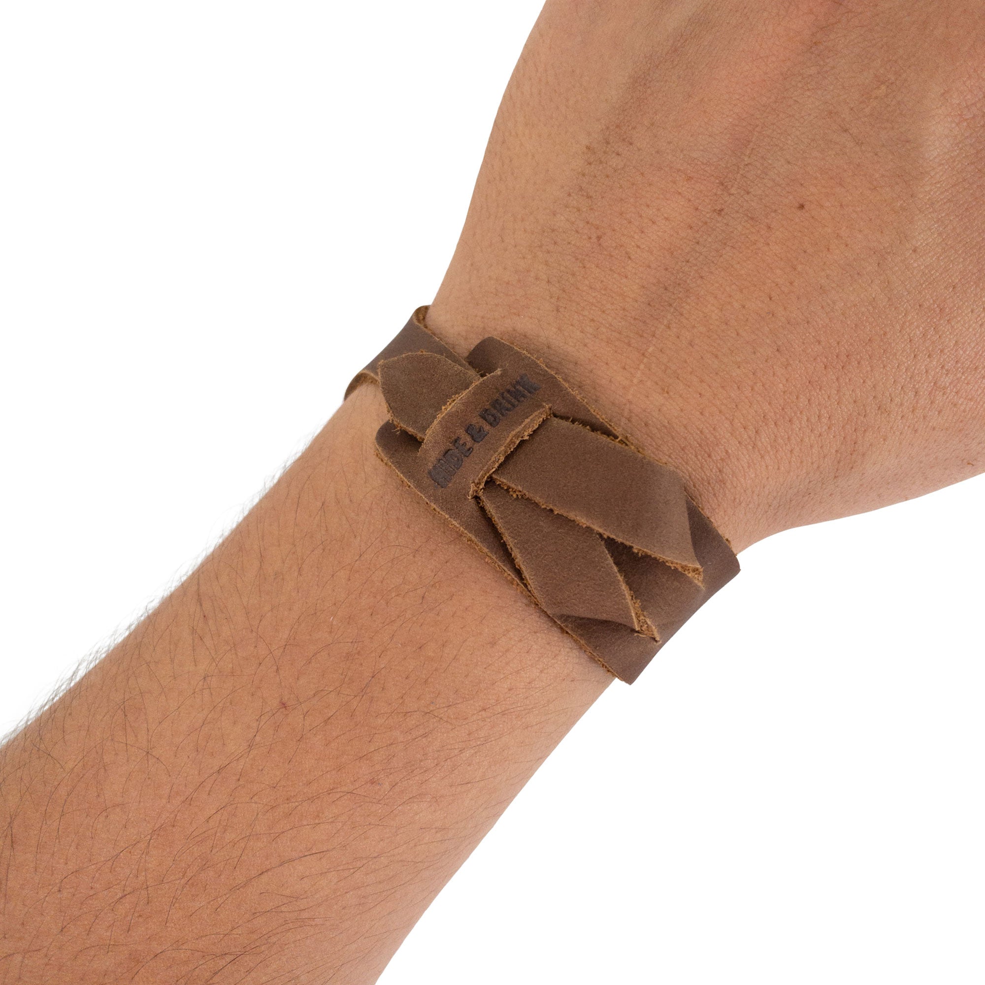 Hide & Drink’s Minimalist Wristband worn, showcasing the light brown leather’s unique tone and handcrafted quality. This adjustable cuff is a stylish bracelet that embodies artisan craftsmanship and care from StockyardX in La Antigua Guatemala.