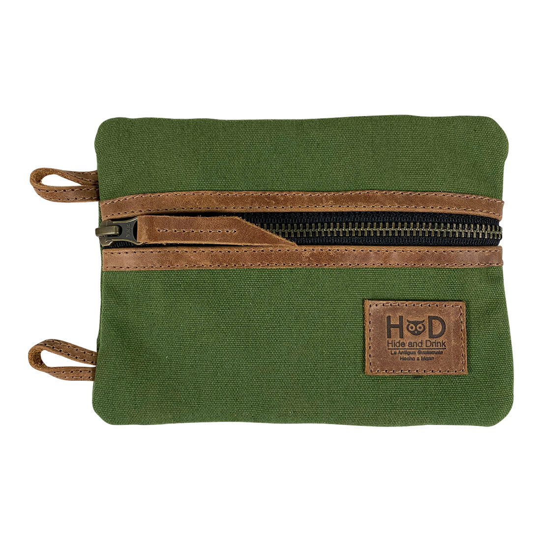 Front view of the green Multi-tool Pocket Pouch - XL by Hide & Drink, highlighting its stylish design and practical usage for organizing smaller tools. Multi-Tool Pocket Pouch XL, Compact Multipurpose EDC Zippered Bag, Knife Holster, Handmade Slim Organizer, Waxed Canvas, StockyardX, Small Batch Production, Hand Cut, Hand Sewn, Artisan, Handmade in La Antigua Guatemala & Oaxaca Mexico.