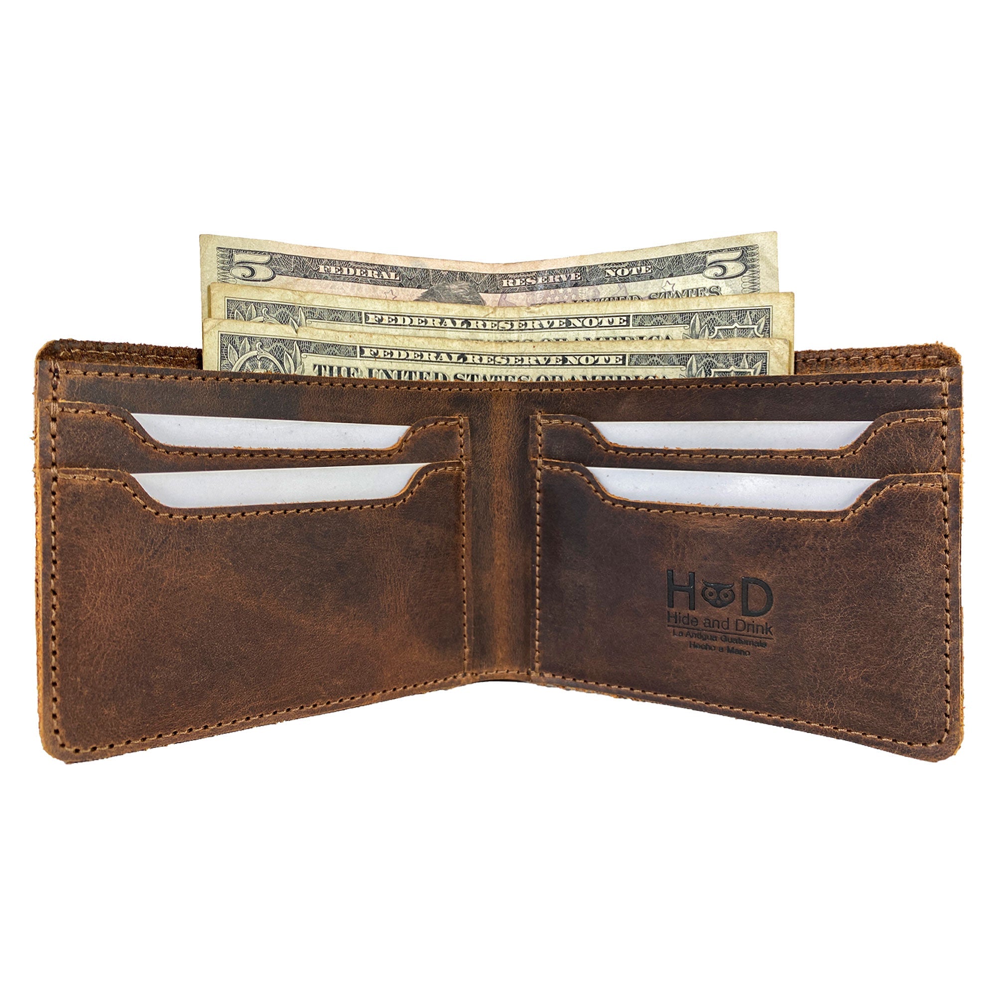 Classic Wallet from Hide & Drink displayed open with cash included, showcasing its multiple card slots. This Classic Bifold Wallet is made of premium Full Grain Leather, serving as a reliable storage case for identification. A great travel accessory, it reflects artisan craftsmanship through small batch production methods. Hand cut and sewn in La Antigua Guatemala & Oaxaca Mexico.