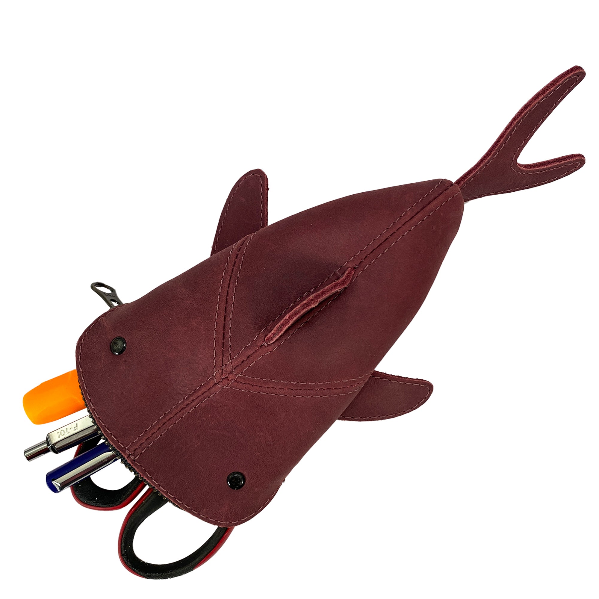 Image of the red Leather Shark Pouch by Hide & Drink showing its zippered functionality. Perfect as a change bag or pencil purse, this charming shark shaped case is created from full grain leather, showcasing high-quality artisan craftsmanship from La Antigua Guatemala & Oaxaca Mexico through small batch production.