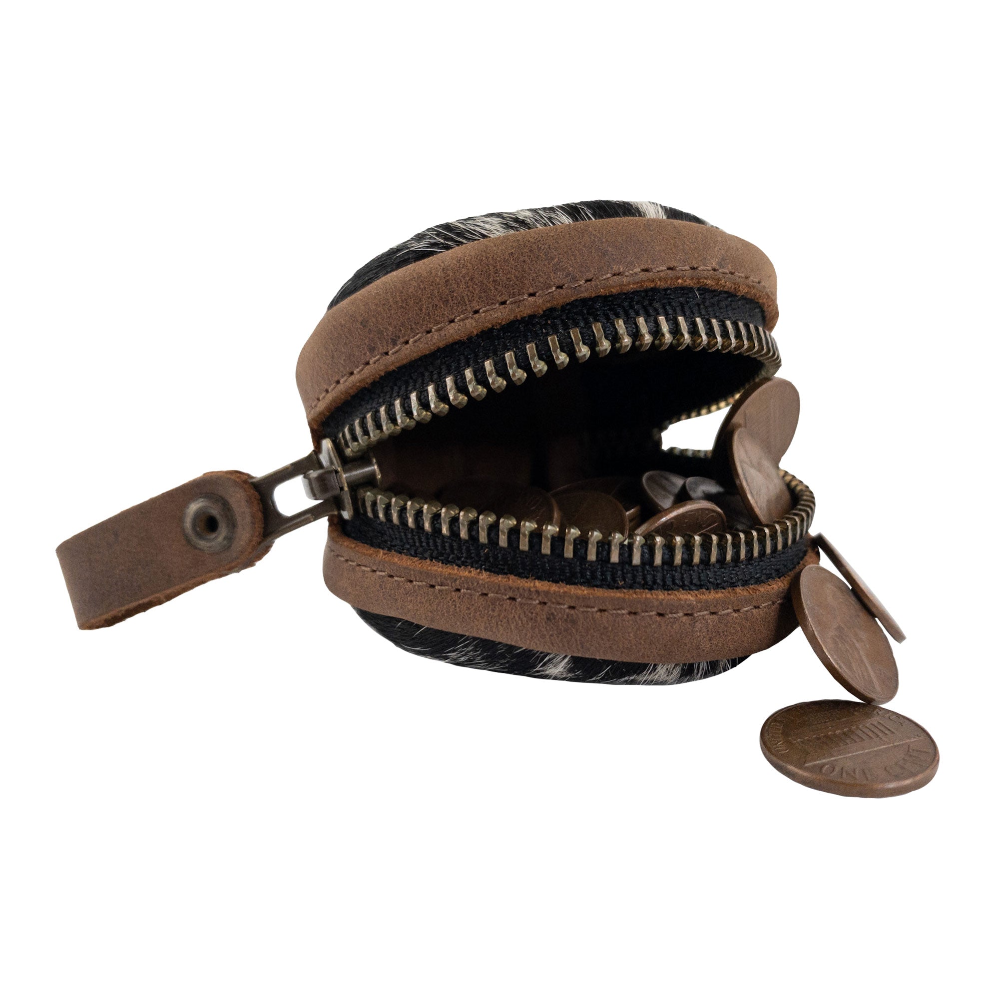 The Rounded Coin Case by Western Leather Works is open, displaying coins inside. This beautiful organizer pouch, crafted from hair-on-hide leather, is perfect for carrying loose change or small essentials while on the go. Made in La Antigua Guatemala, it features small batch production artistry that sets it apart.