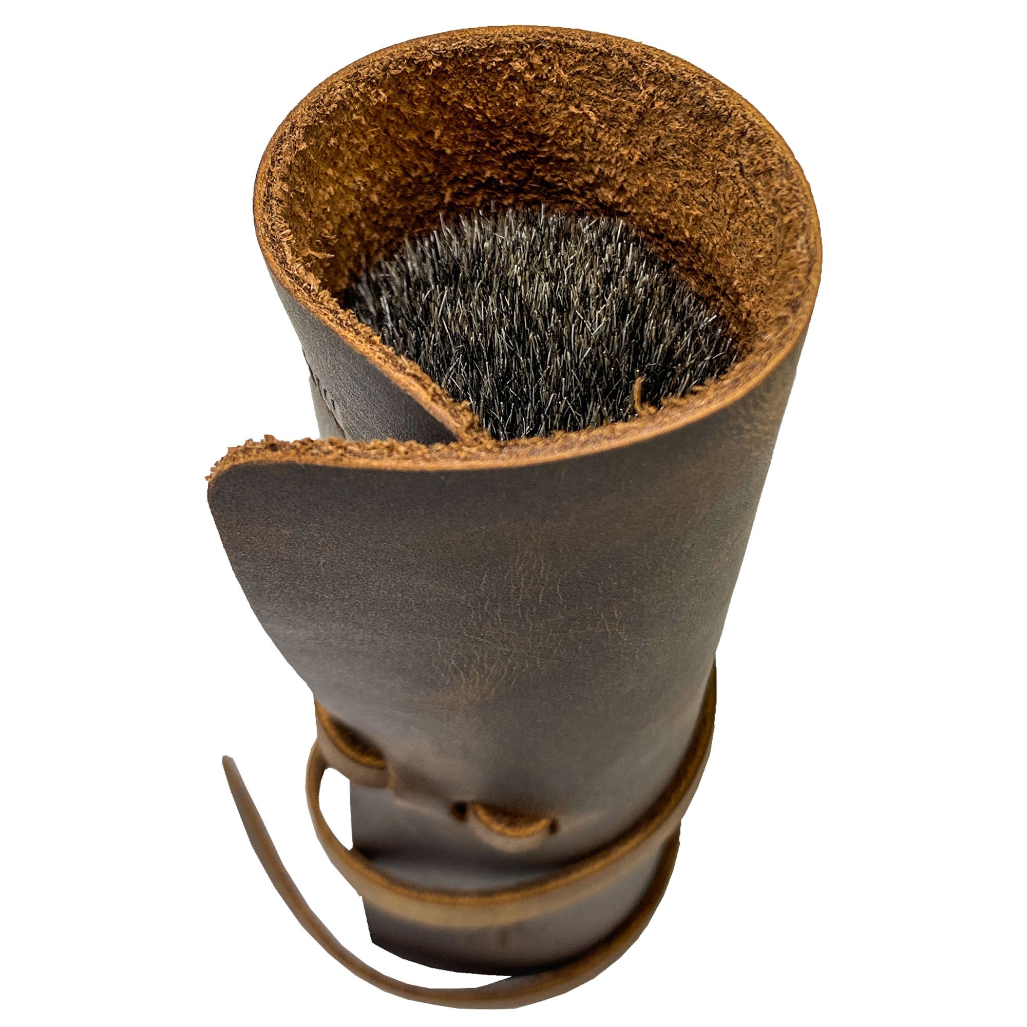 Hide & Groom Shaving Brush Roll features a stylish full grain leather construction, perfect for organizing shaving essentials while traveling. This handmade roll, designed in minimalist style, showcases artisan quality from La Antigua Guatemala. Each piece is part of a small batch production, hand cut, hand sewn, and fire branded.