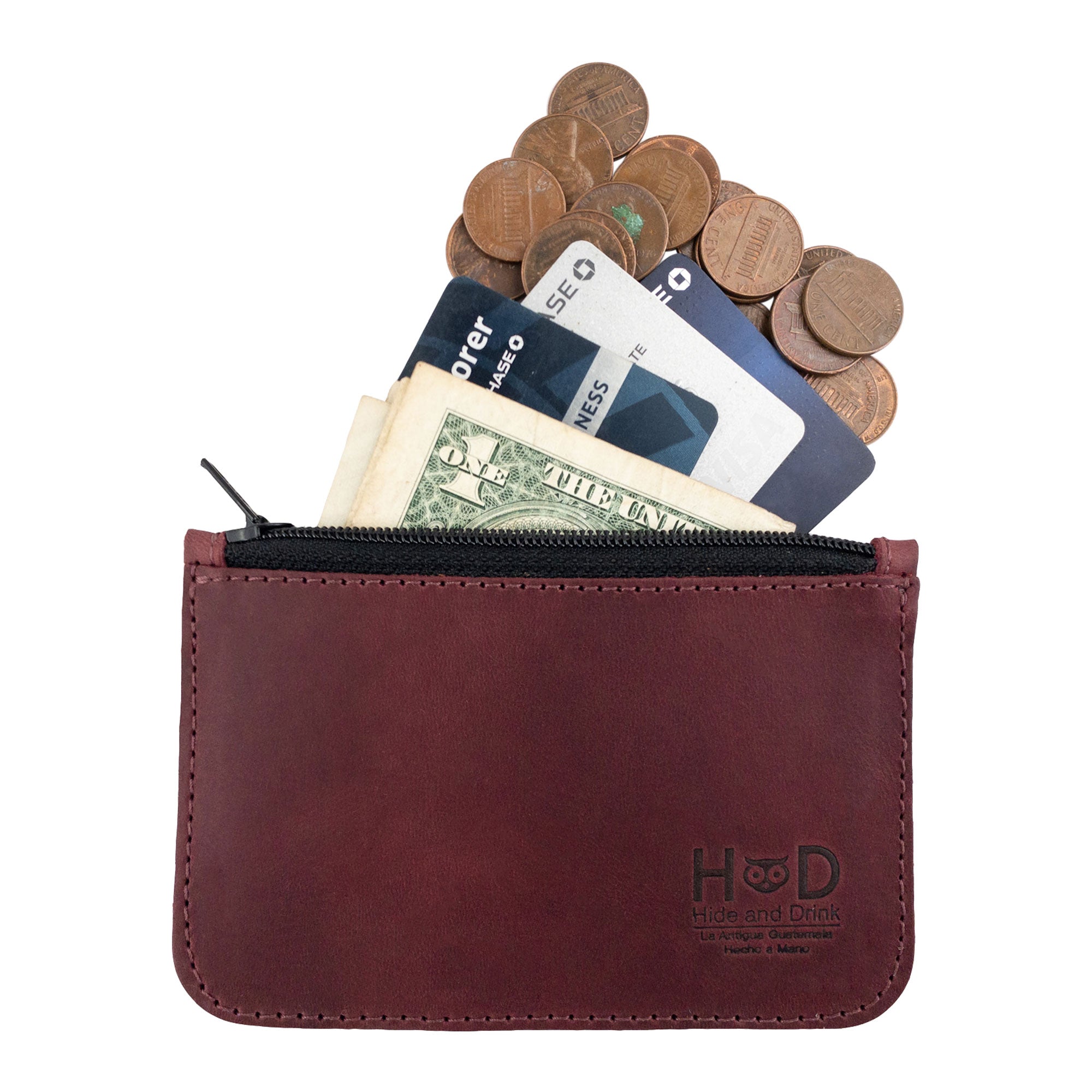 Open view of the Hide & Drink zippered wallet filled with coins and cards, demonstrating its functionality as a Zip Wallet, a great Travel Accessory made from artisan-crafted Full Grain Leather.