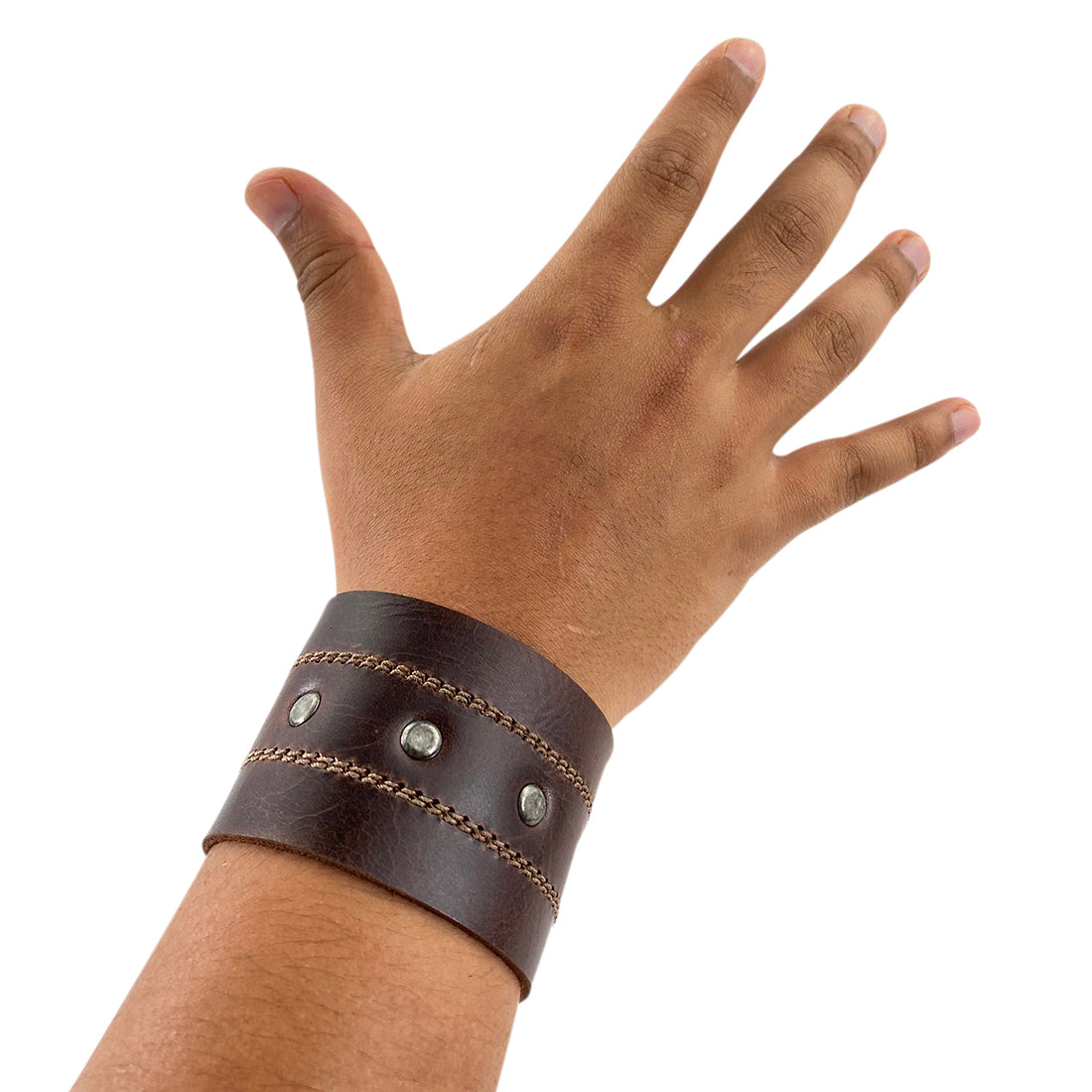 A model showcasing the Men's Wristband by Hide & Drink, highlighting its fit and aesthetic appeal. This stylish full grain leather wristband adds an edgy touch to any outfit, lovingly crafted by artisans. Men's Wristband Handmade, Full Grain Leather, StockyardX, Small Batch Production, Hand Cut, Hand Sewn, Fire Branded, Artisan, Handmade in La Antigua Guatemala & Oaxaca Mexico.