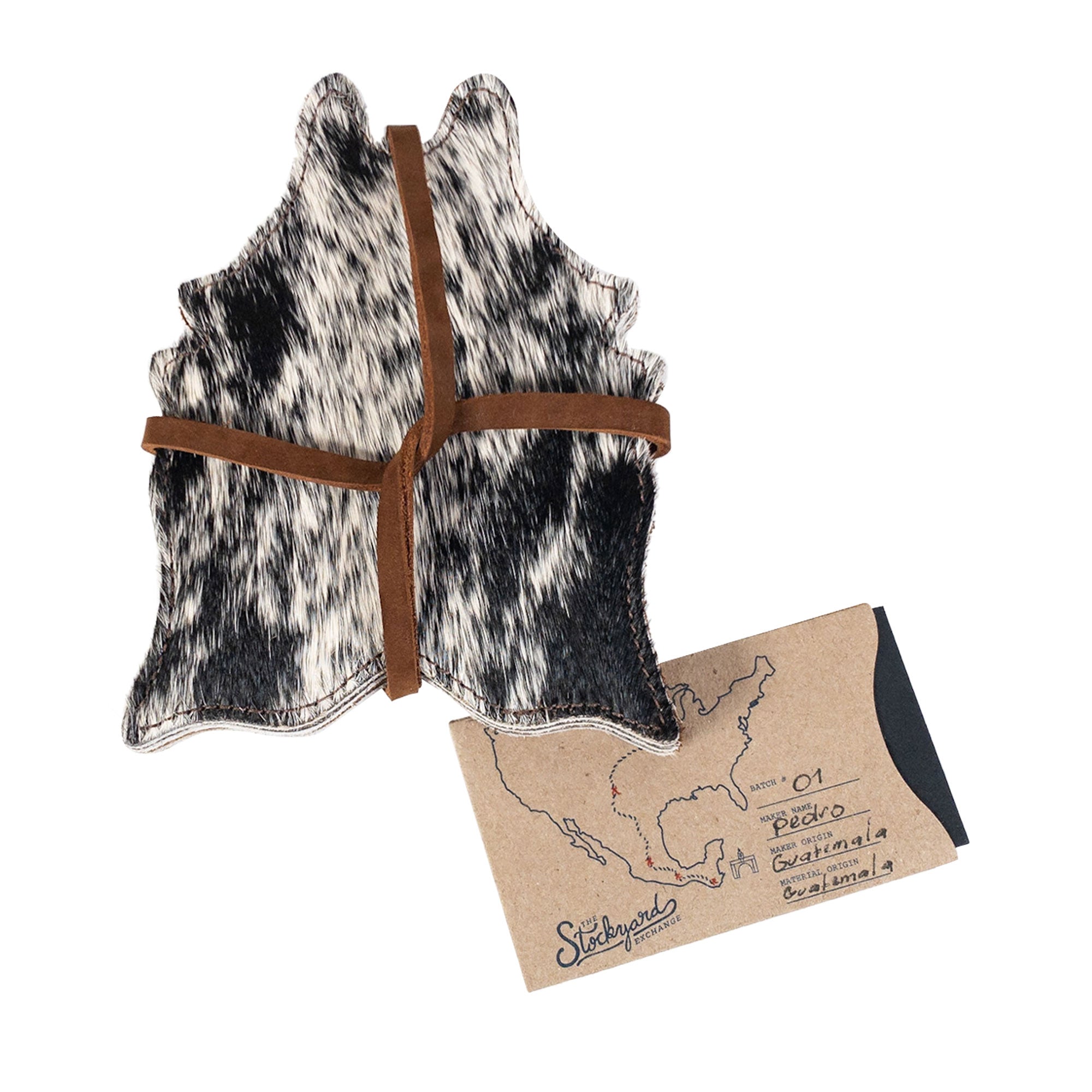 Hand-tied Cowhide Shape Set of 6 Coasters from Western Leather Works presented with a rustic label. Made from Hair On Hide Full Grain Leather, these artisan coasters are perfect for drinks and handcrafted in La Antigua Guatemala & Oaxaca Mexico.