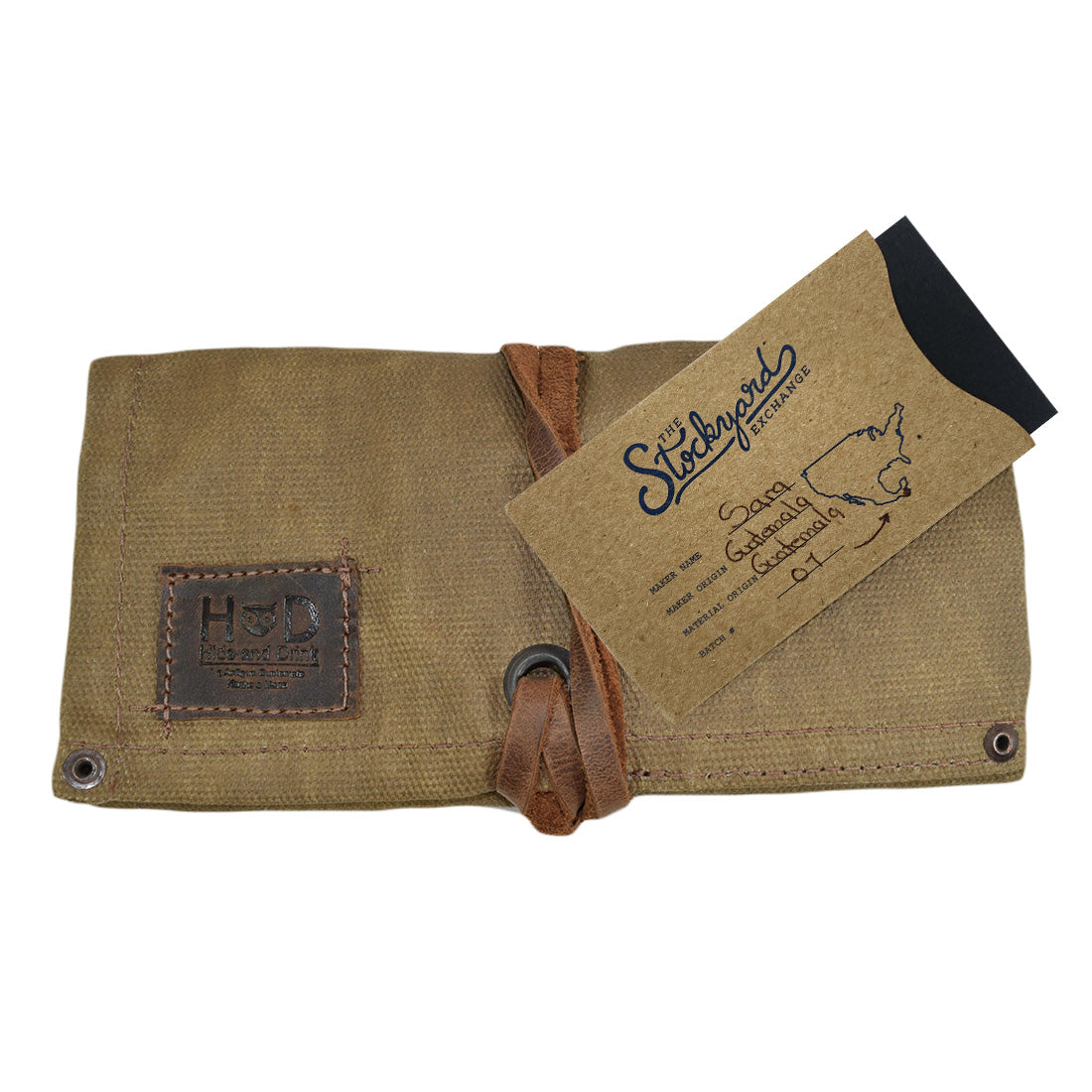 The Waxed Canvas Watch Roll by Hide & Drink, complete with a branding tag, reflects artisan quality and functionality. This handmade organizer holds up to 4 watches, made in Guatemala and Mexico.