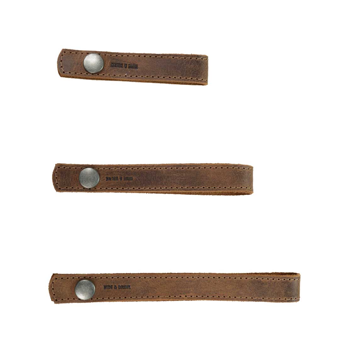 Three unique curtain tiebacks from Hide & Drink, ideal for thin or thick window drapes. This Curtain Tieback (6 Pack) features accessories made from full grain leather, perfect for home and office decoration. Artisan crafted, hand cut, and hand sewn in La Antigua Guatemala & Oaxaca Mexico, these durable tiebacks ensure style and functionality.