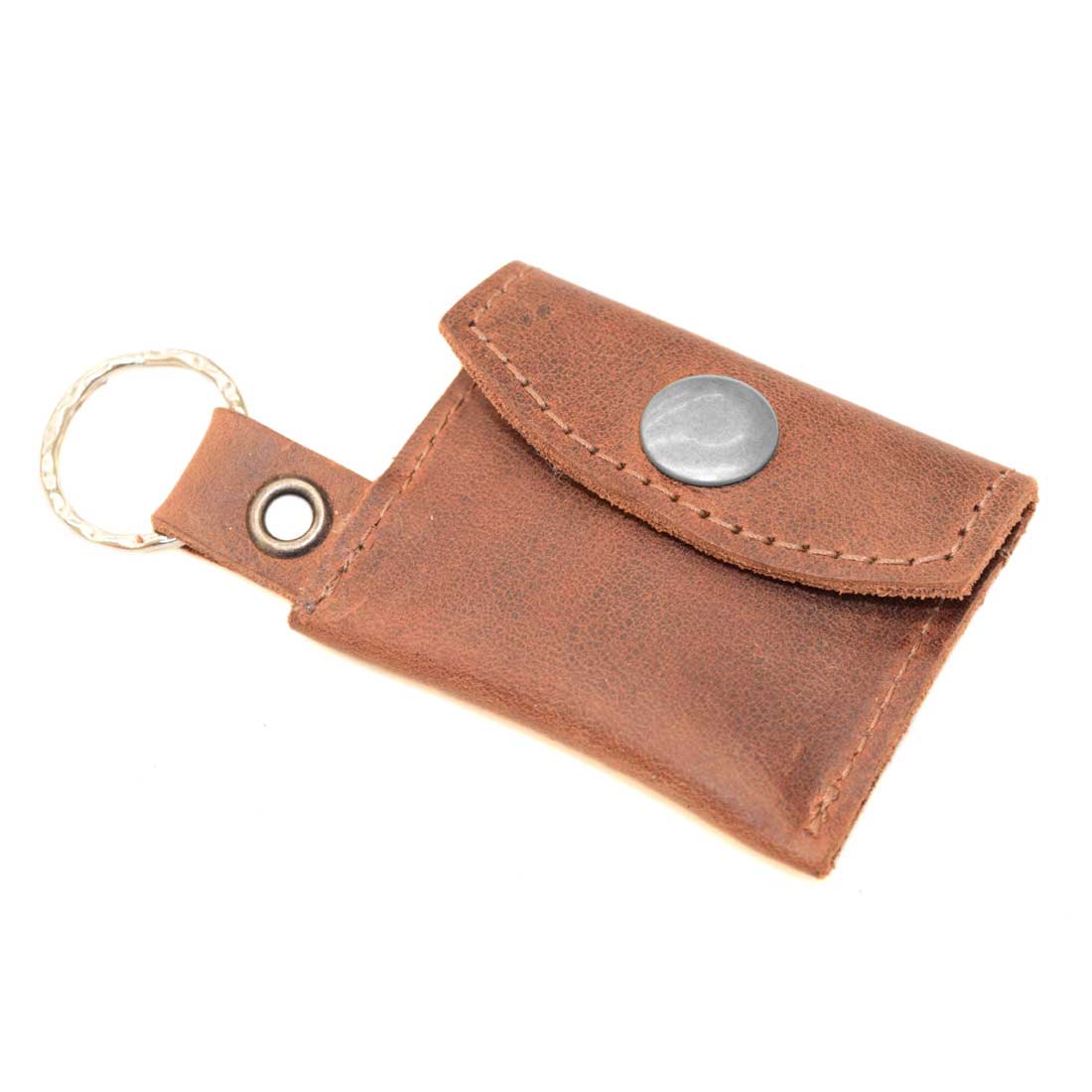 Tiny Coin Holder Keychain by Hide & Drink, featuring a hand-stitched design made of Full Grain Leather. This Tiny Coin Holder is perfect for carrying coins and keys, boasting Small Batch Production and Artisan craftsmanship, Handmade in La Antigua Guatemala.