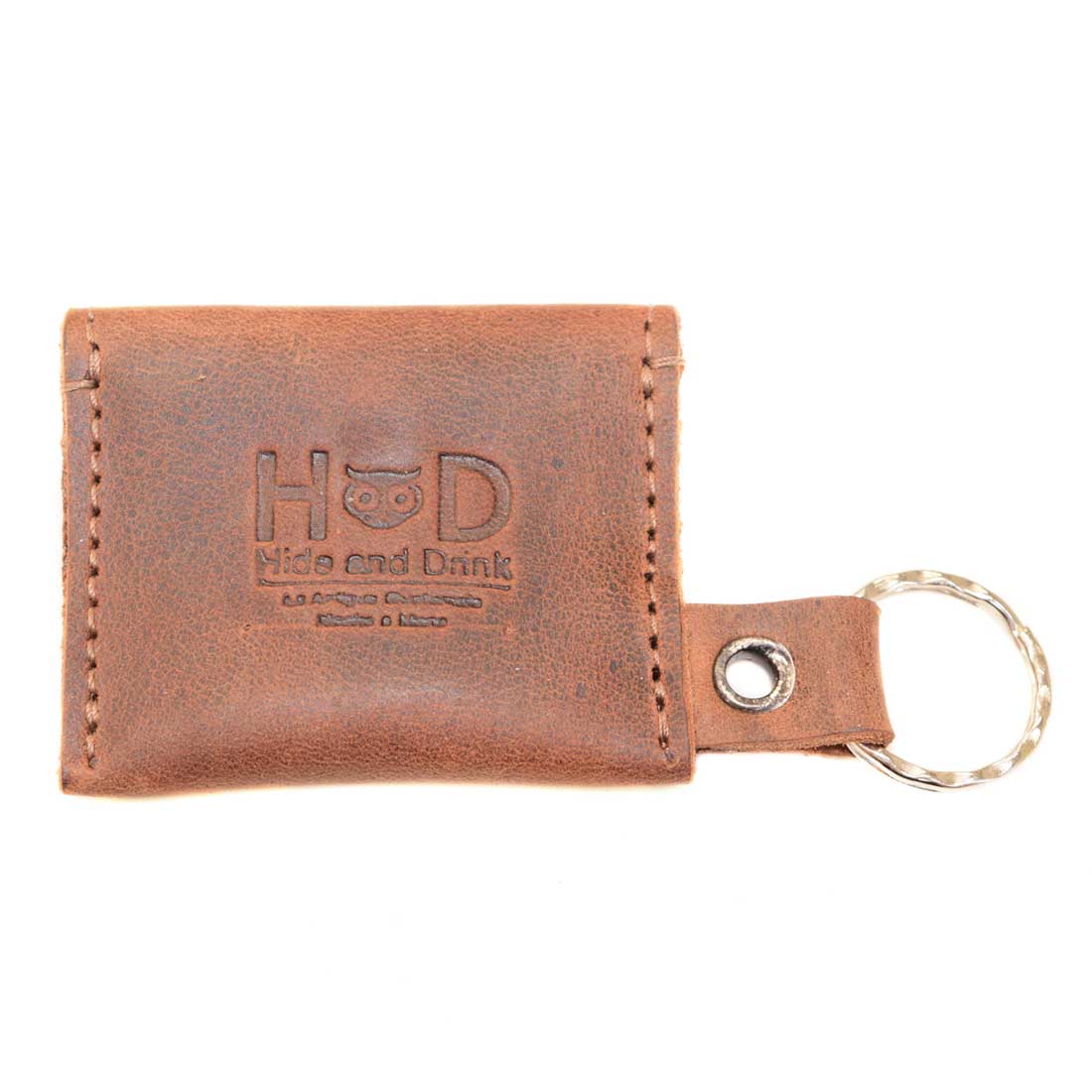 The front view of Tiny Coin Holder Keychain by Hide & Drink, emphasizing its stylish design and durable Full Grain Leather. This artisan product represents small batch production, adding elegance to your keys and coins, handmade in La Antigua Guatemala.